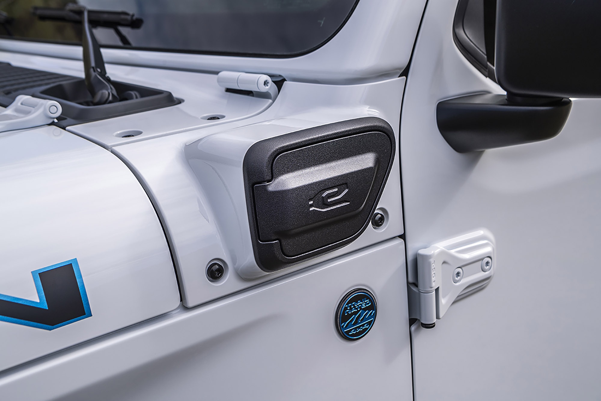 Detail shot of the charging port on a white Jeep Wrangler 4xe