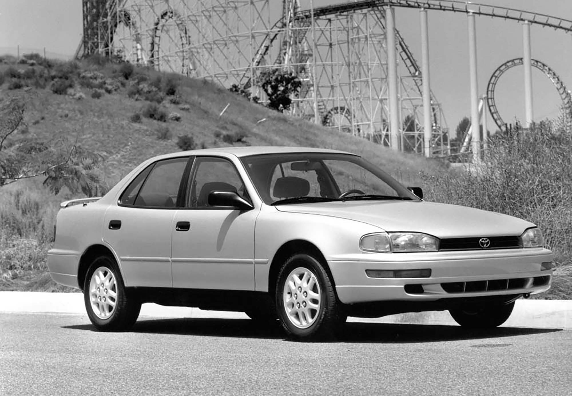 1993 Toyota Camry parked in front of a roller coaster.