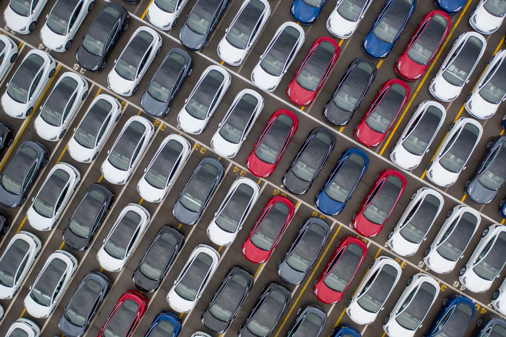Dozens of Teslas in a parking lot
