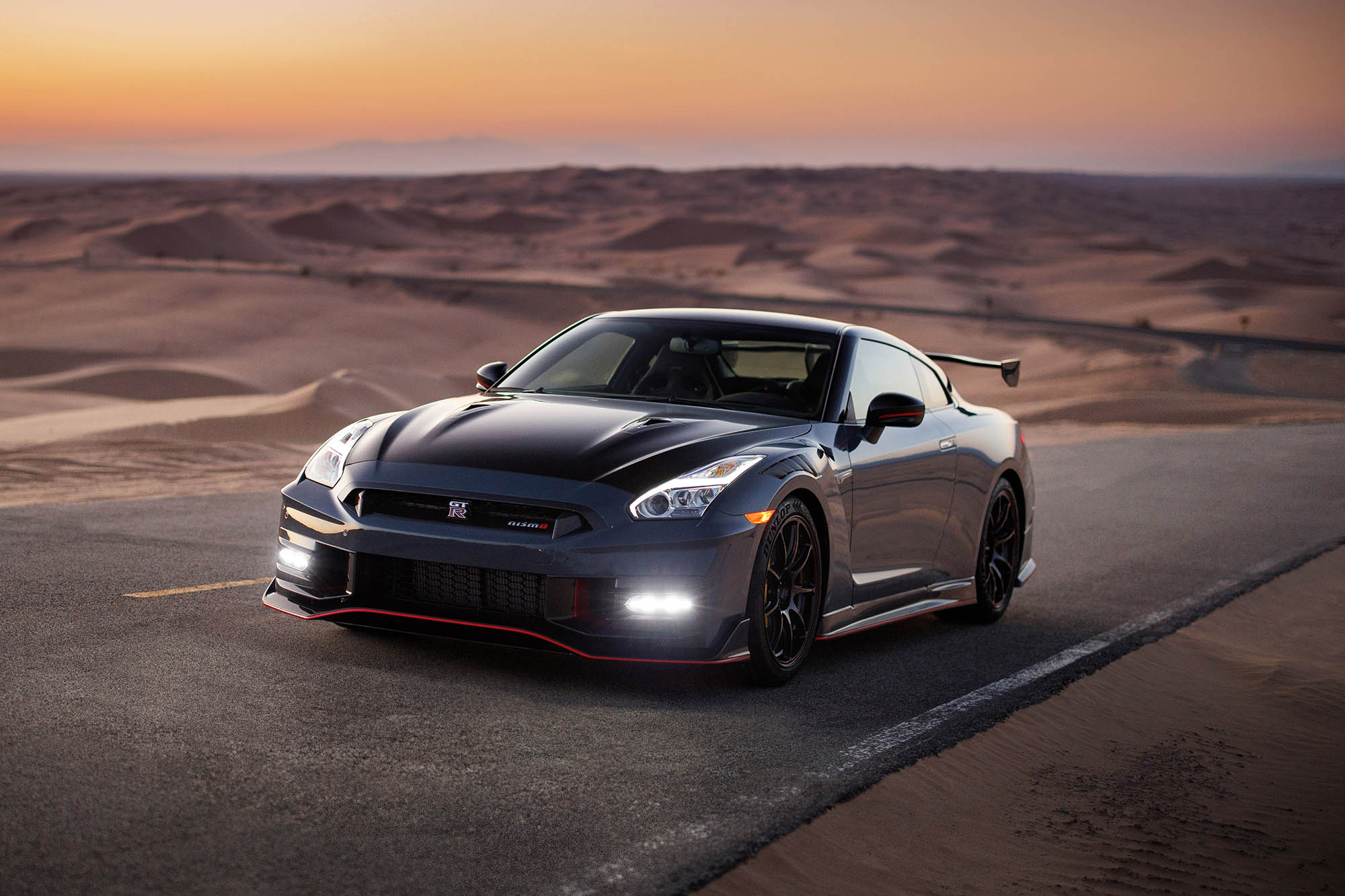 A gray 2024 Nissan GT-R Nismo parked on a desert road