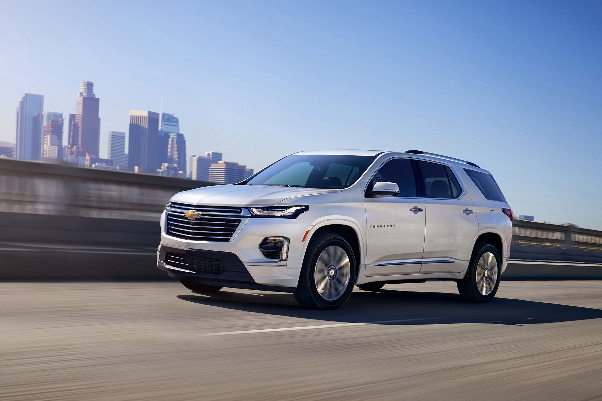 2023 Chevrolet Traverse in white driving in front of Downtown Los Angeles