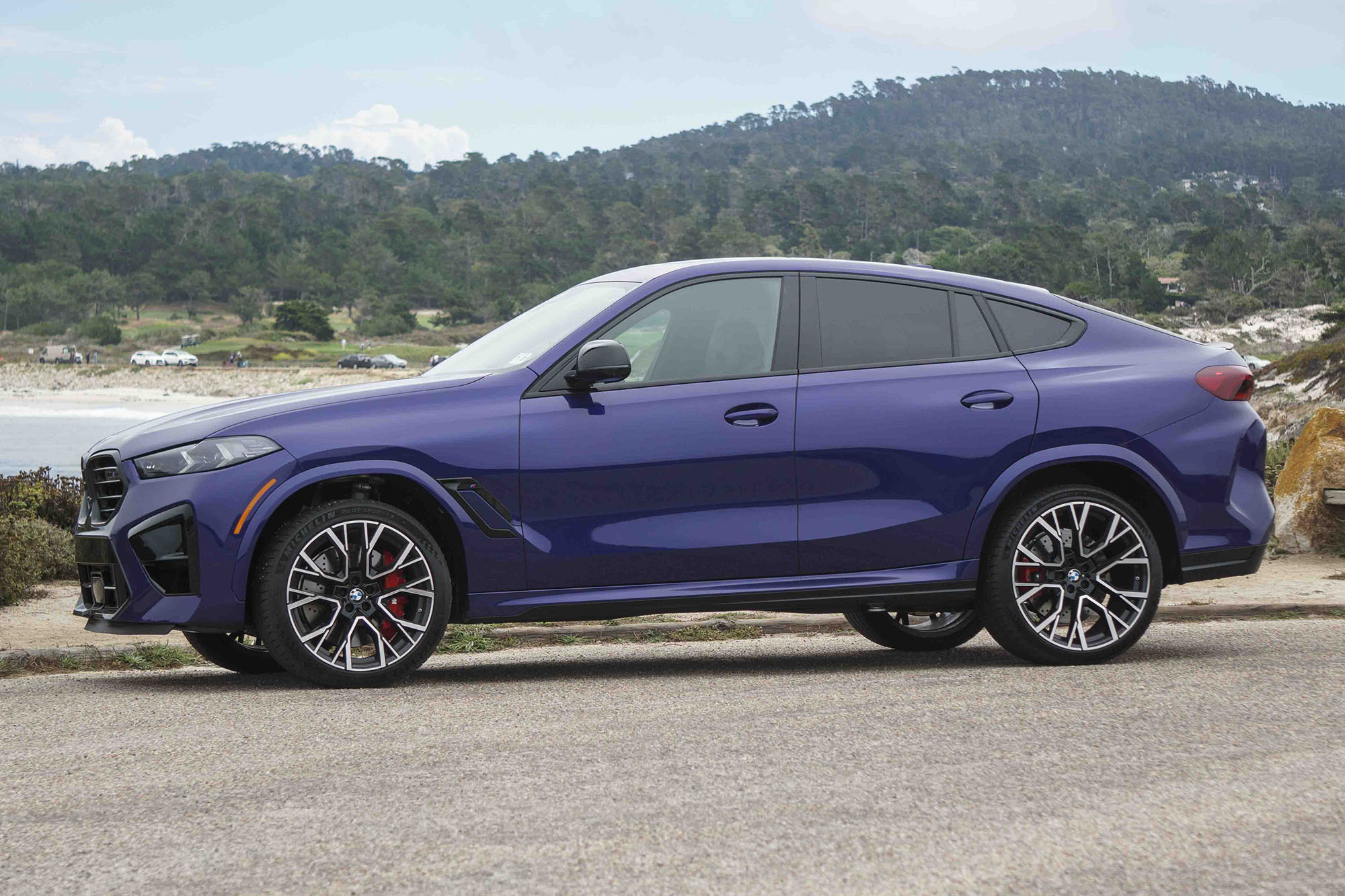 Side view of a blue 2024 BMW X6 M