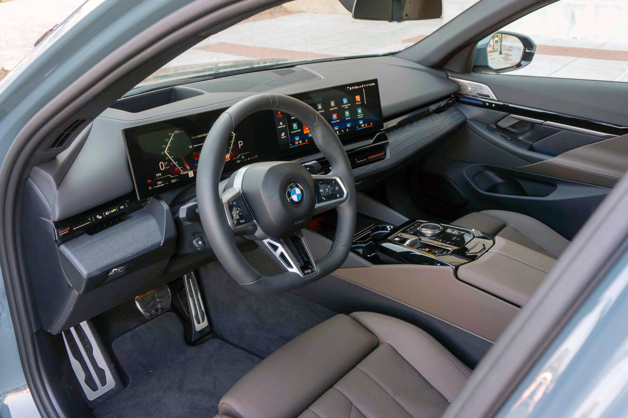 2025 BMW 5 Series front seats and steering wheel.