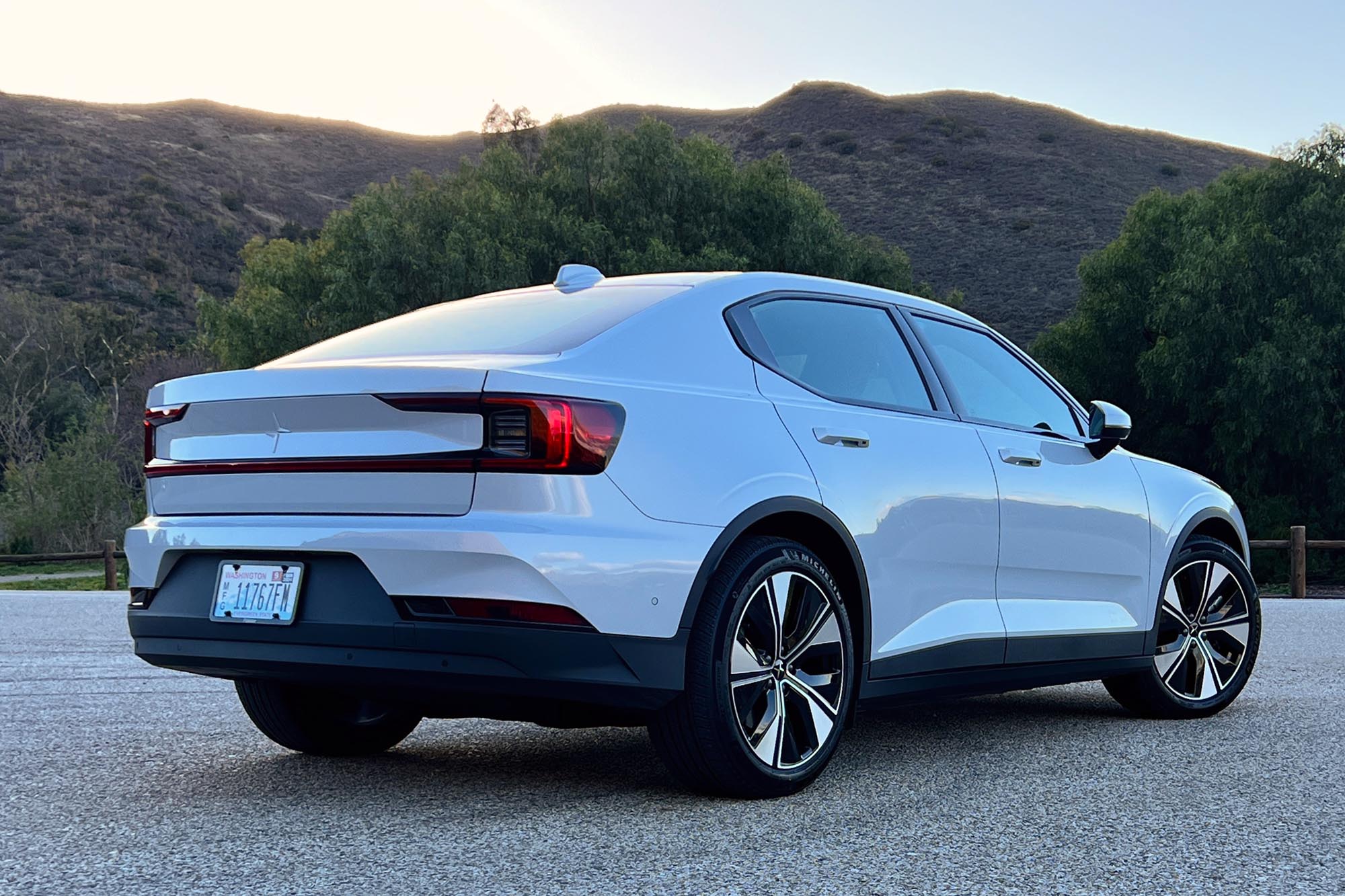 Right-rear-quarter view of a white Polestar 2