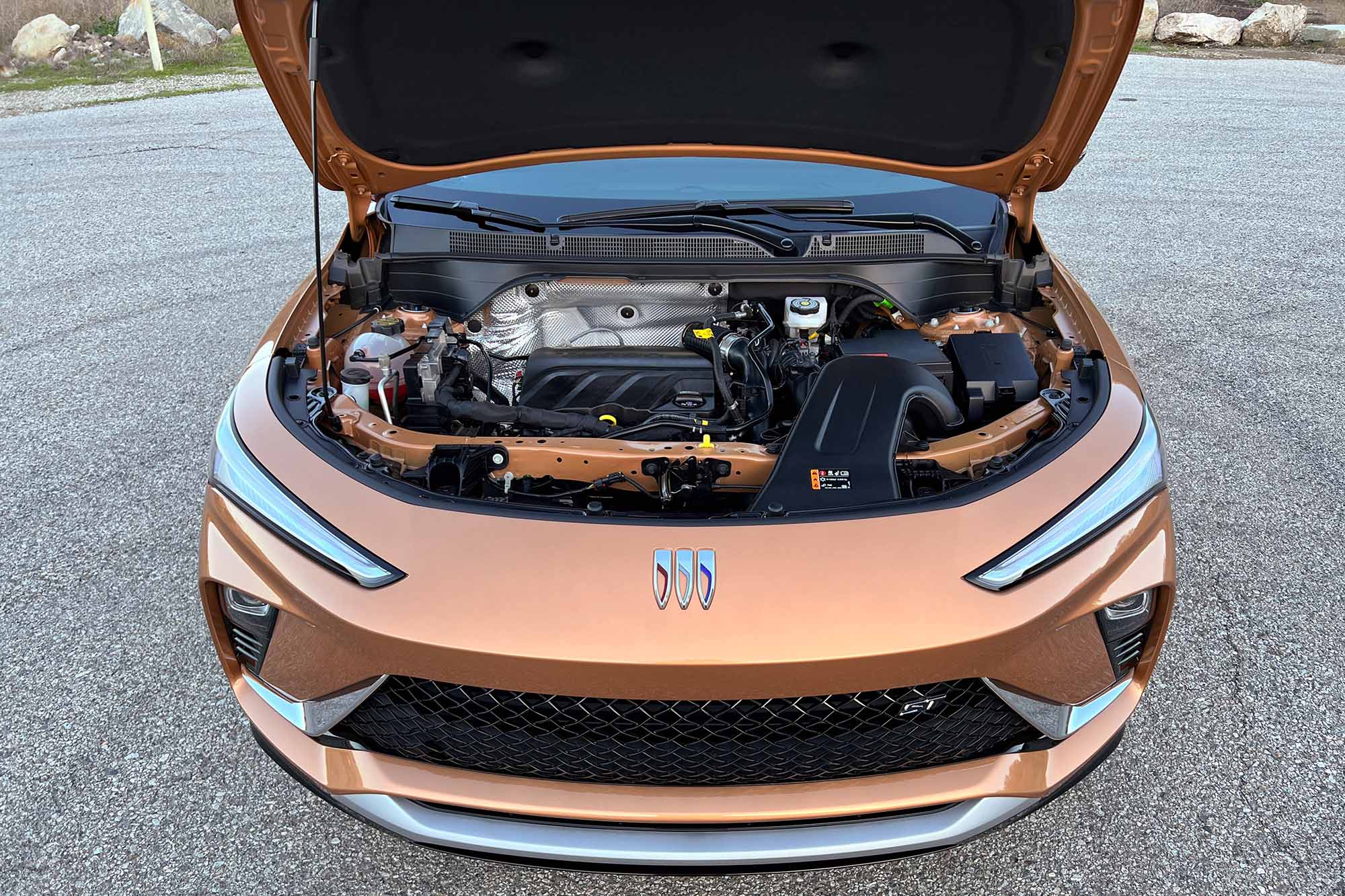 The engine bay of an orange 2024 Buick Envista