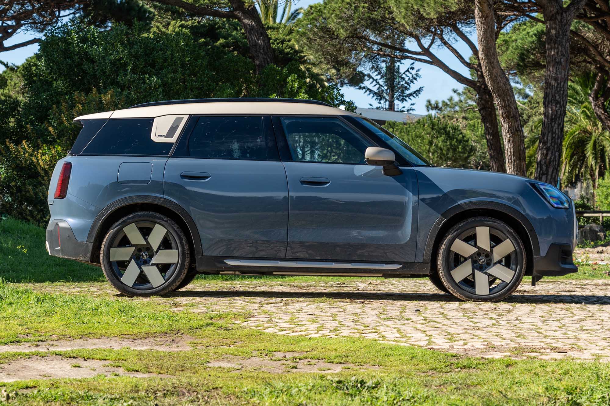 Side view of a blue 2025 Mini Countryman SE with a white roof