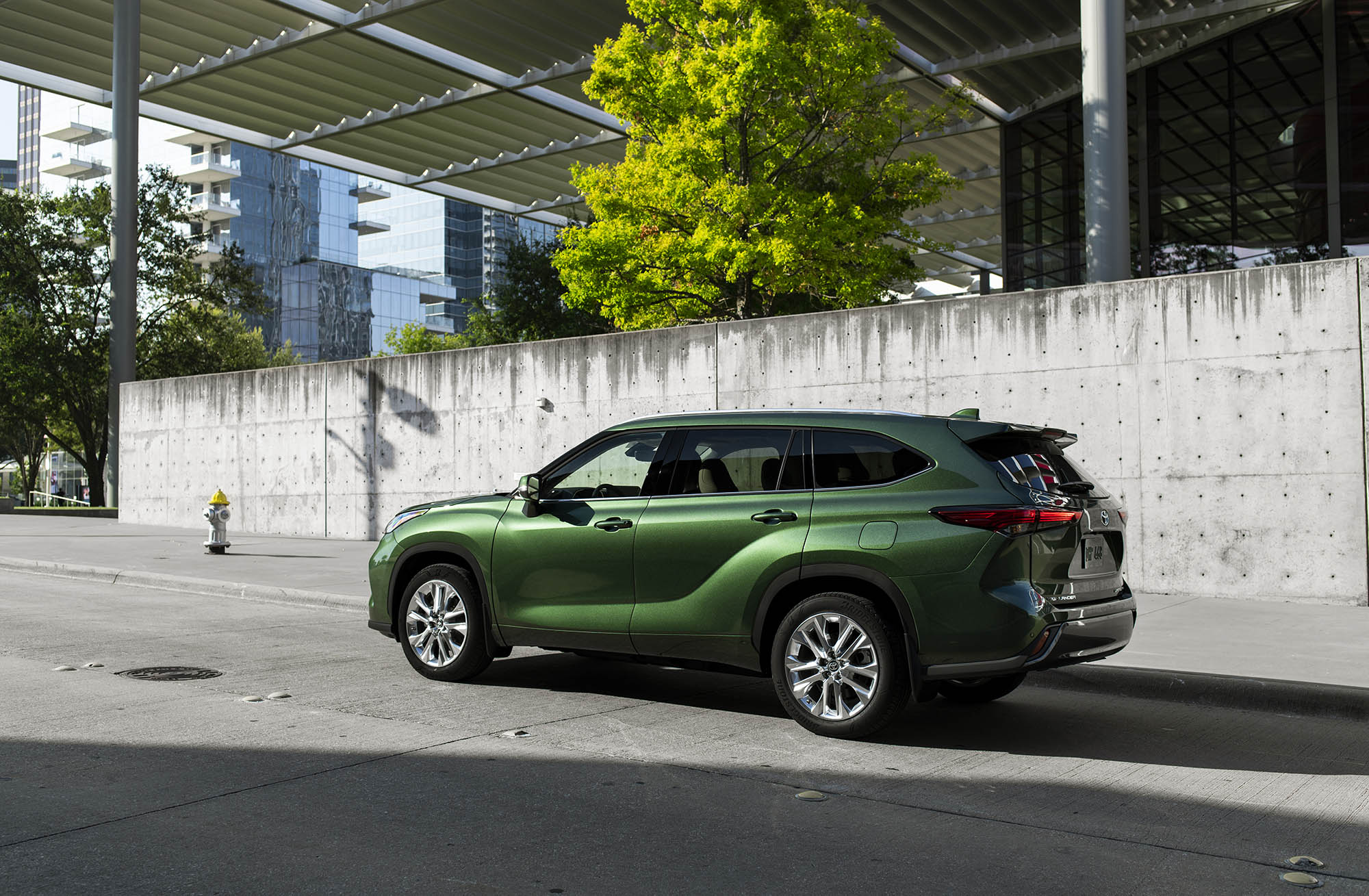 Green 2024 Toyota Highlander parked in urban area
