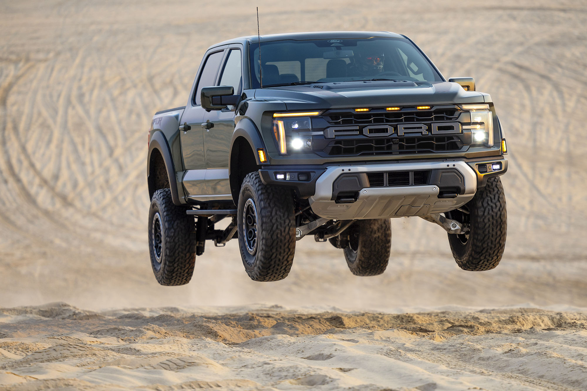 A 2024 Ford F-150 Raptor taking a jump in the desert