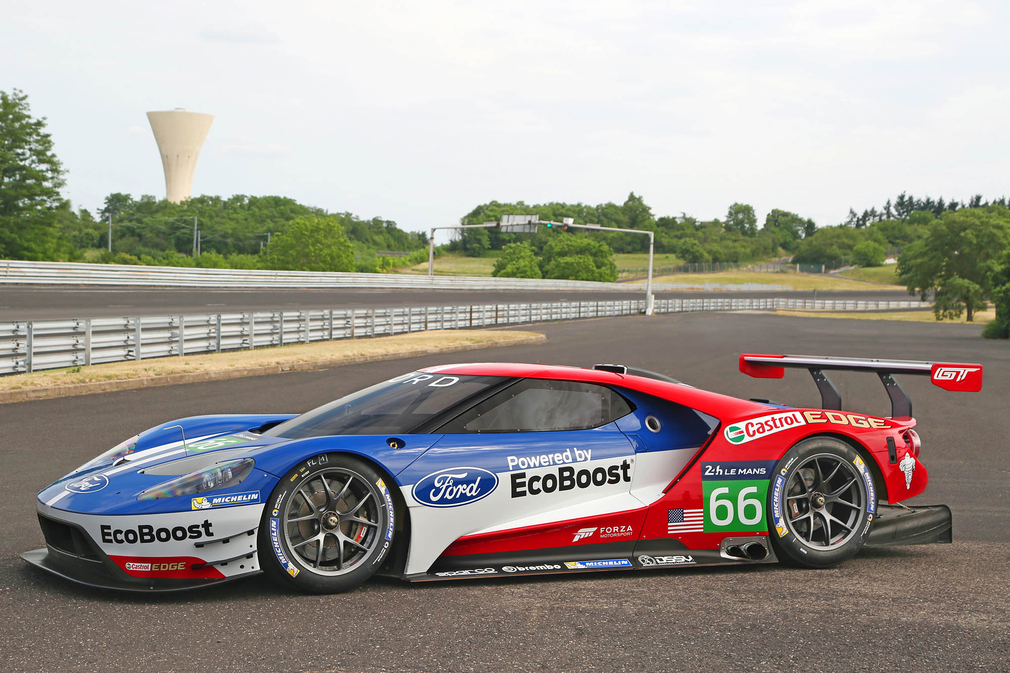 Side view of a red, white, and blue Ford GT race car
