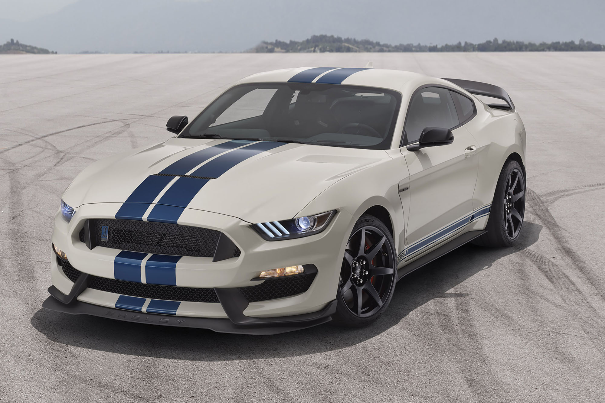 Front left quarter view of a blue and white 2020 Mustang Shelby GT350 on a skidpad
