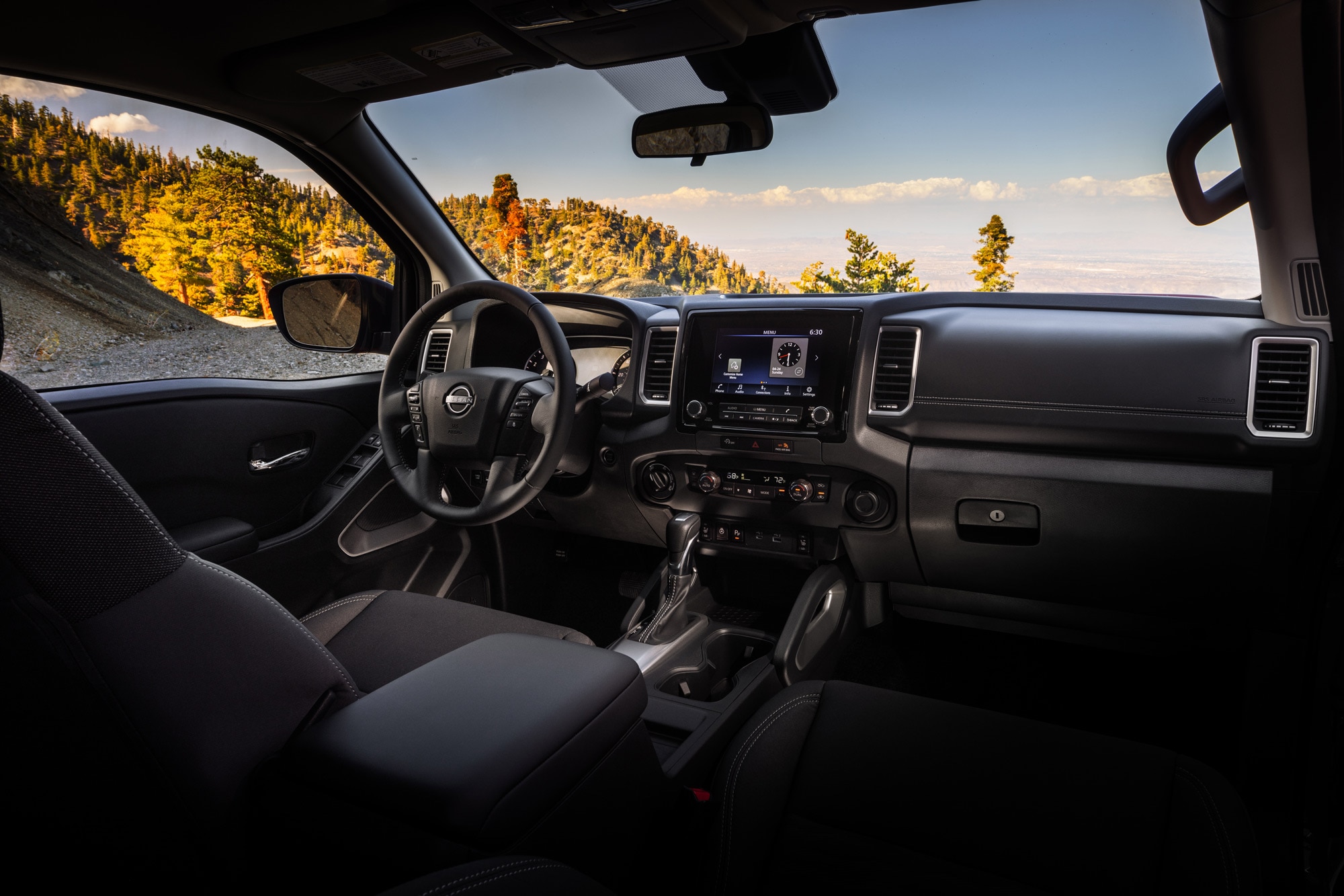 2024 Nissan Frontier interior and infotainment screen.