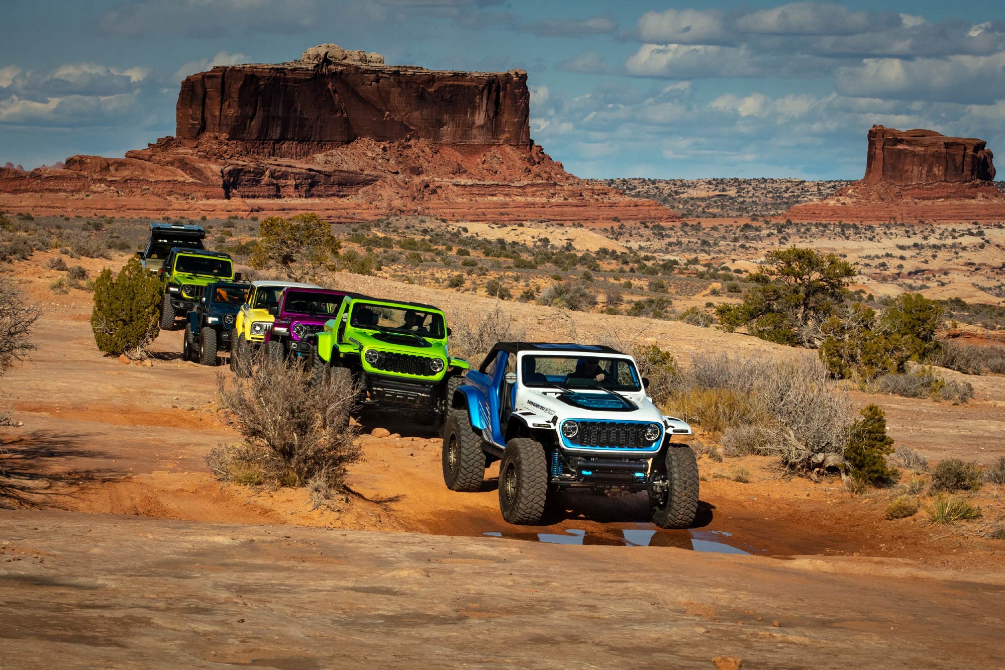 Several Jeeps traverse the wilderness near Moab