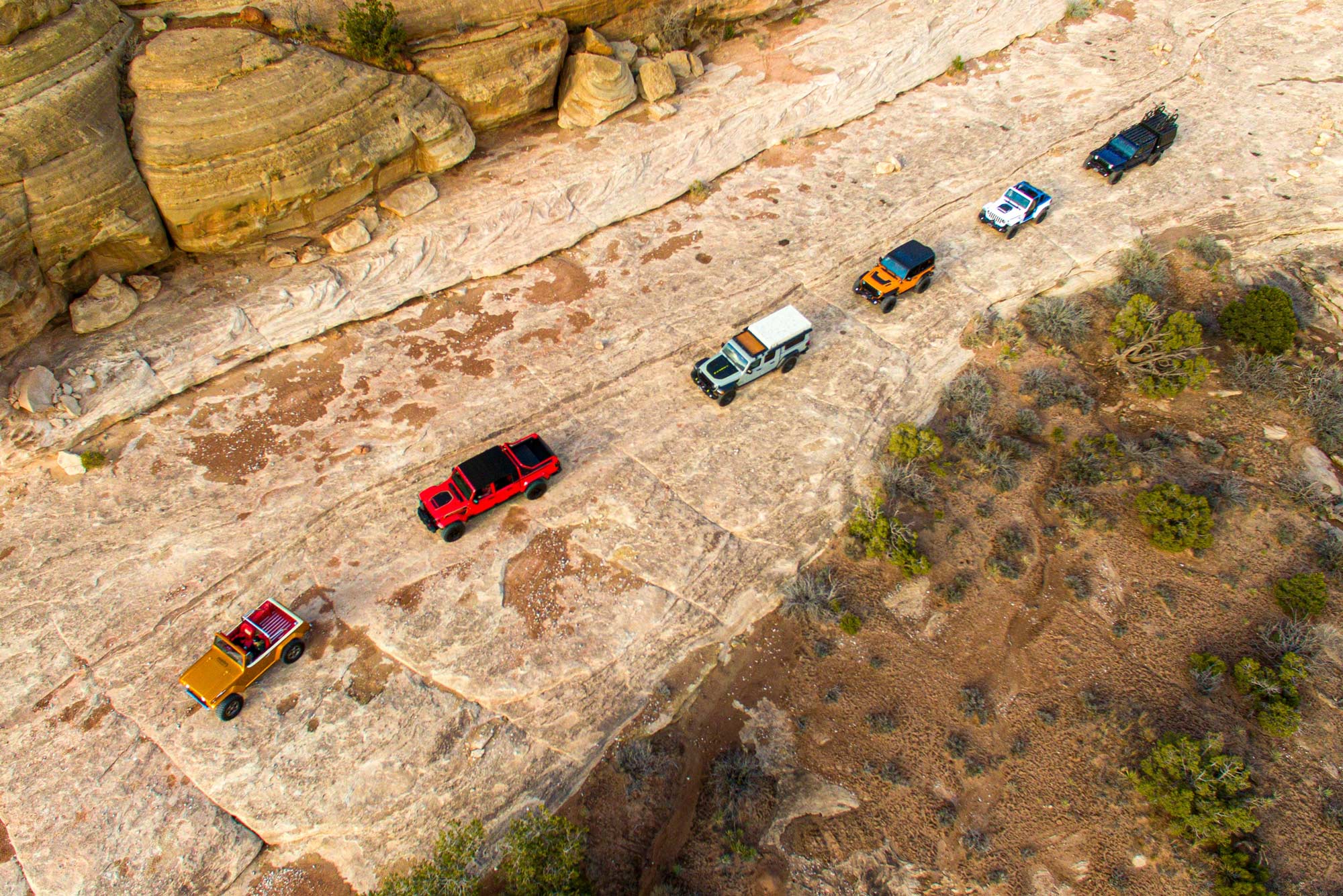 Several Jeeps traverse the rocks near Moab