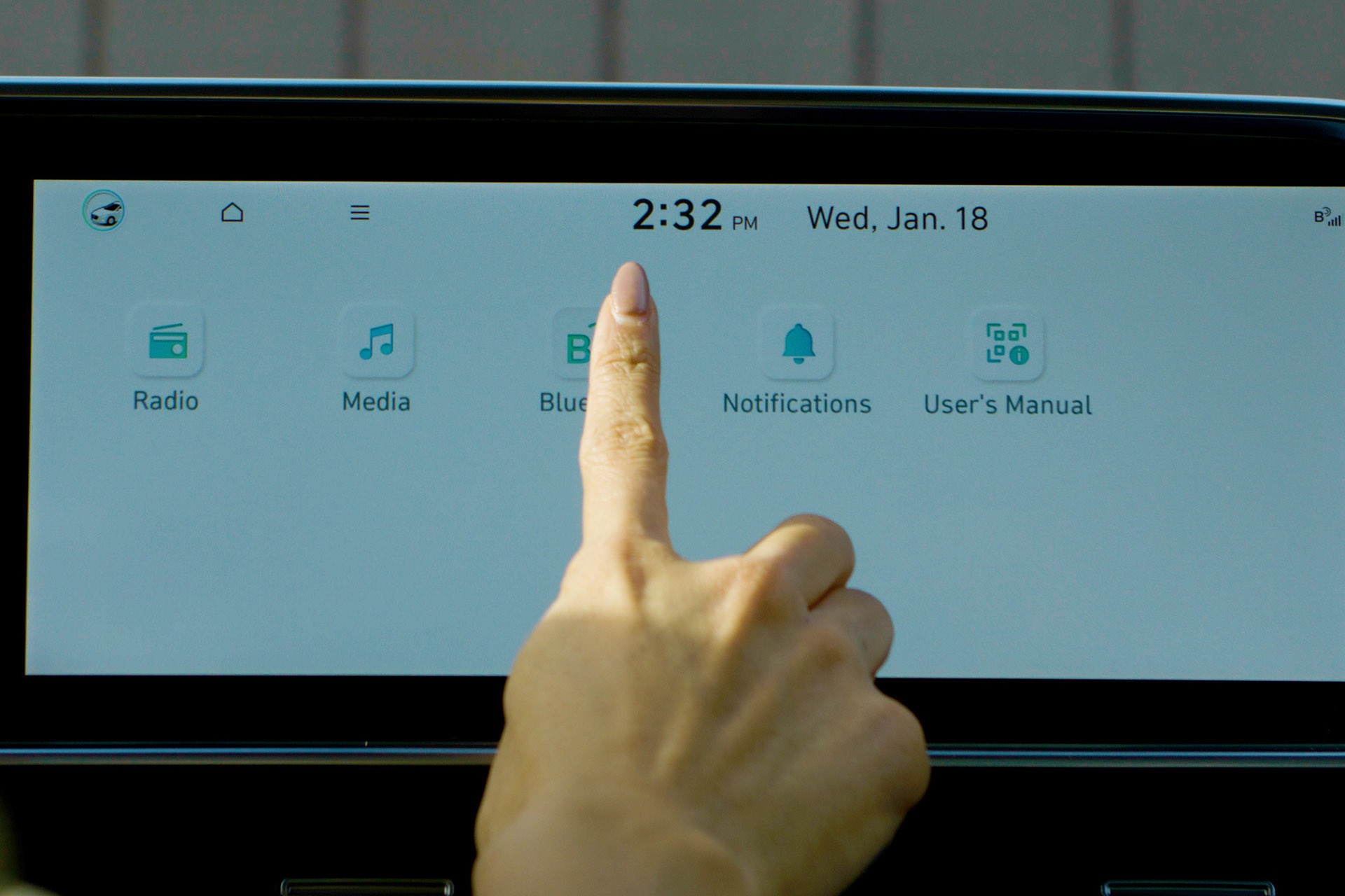 Person's hand hovers over Hyundai infotainment screen