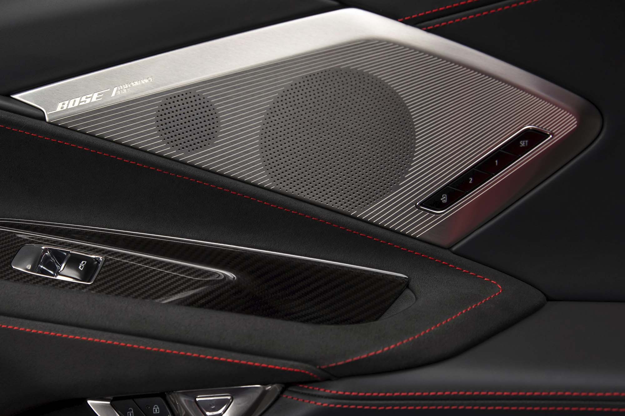 A silver Bose speaker grille in the door of a 2020 Chevrolet Corvette Stingray