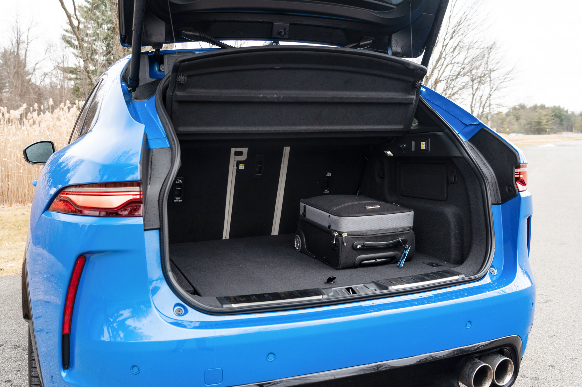 2024 Jaguar F-Pace SVR cargo area with a rolling suitcase inside.