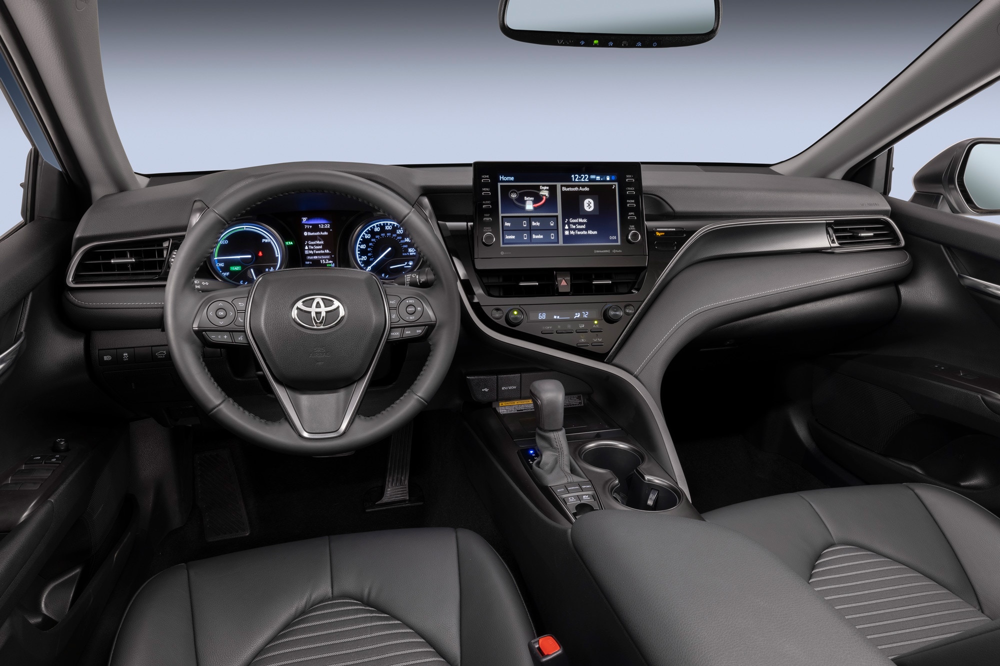 2024 Toyota Camry interior, steering wheel, and infotainment screen.