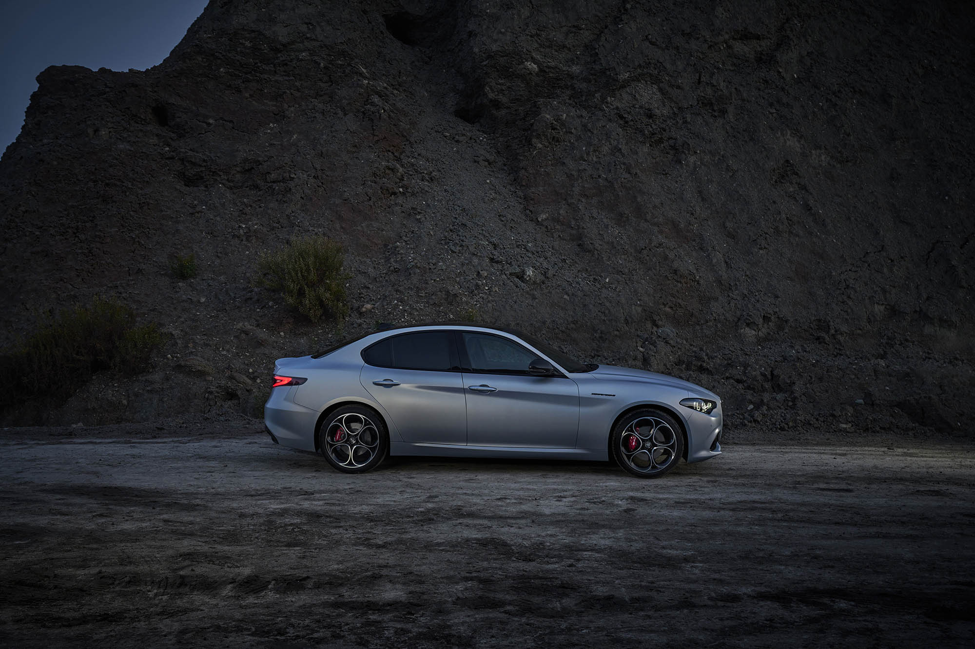 Alfa Romeo Giulia in silver matte paint parked on dirt road