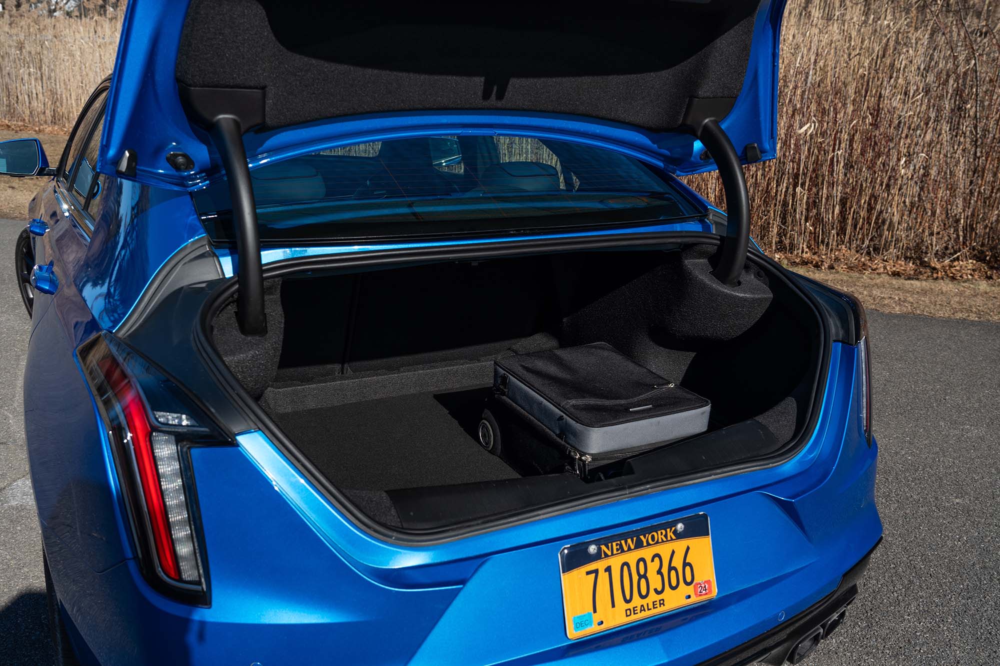 2024 Cadillac CT4-V Blackwing trunk with a roll-aboard suitcase inside.