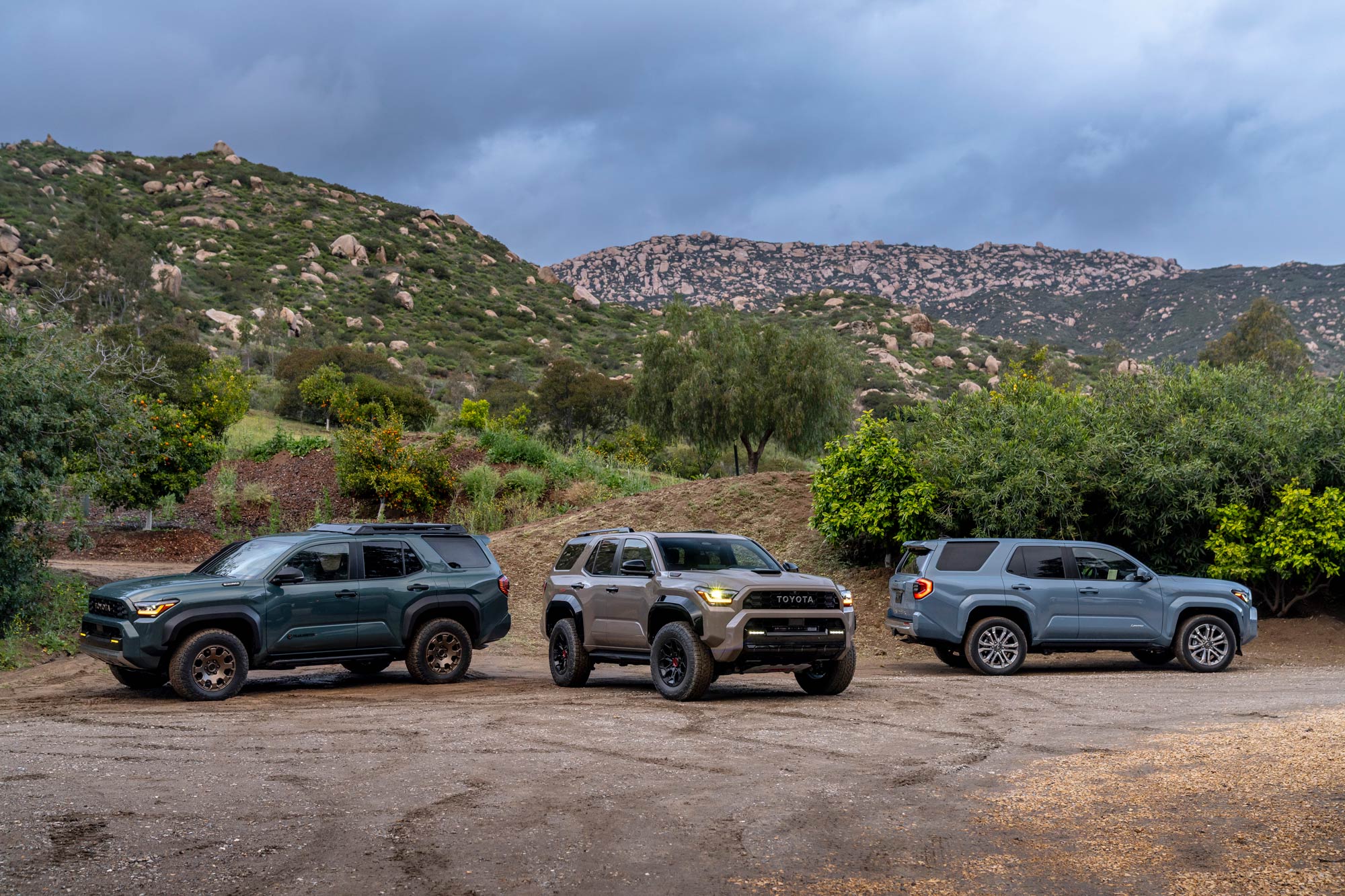 Three 2025 Toyota 4Runners parked off-road in the mountains.