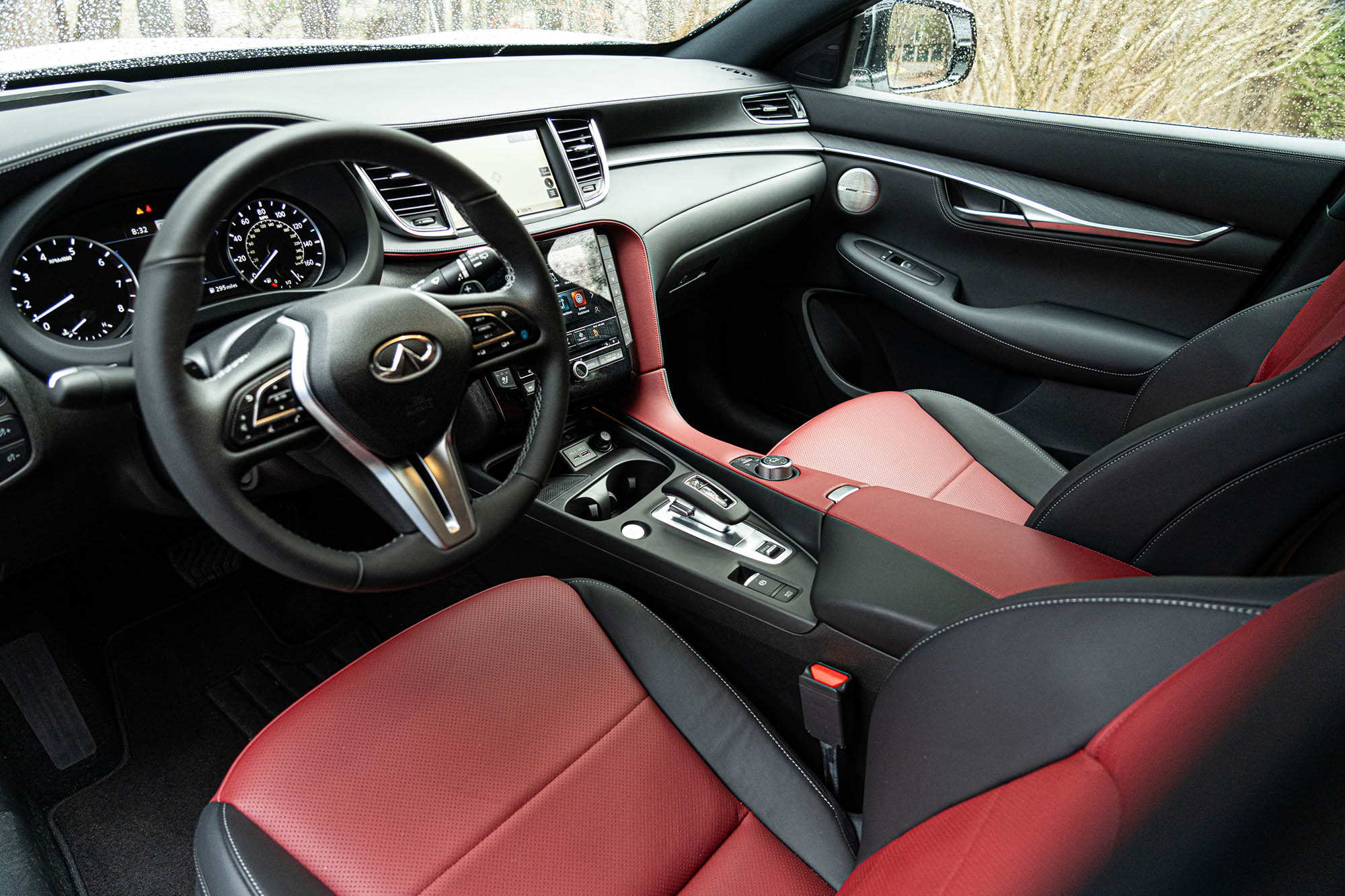 The dashboard and front seats of a 2024 Infiniti QX55 equipped with red leather