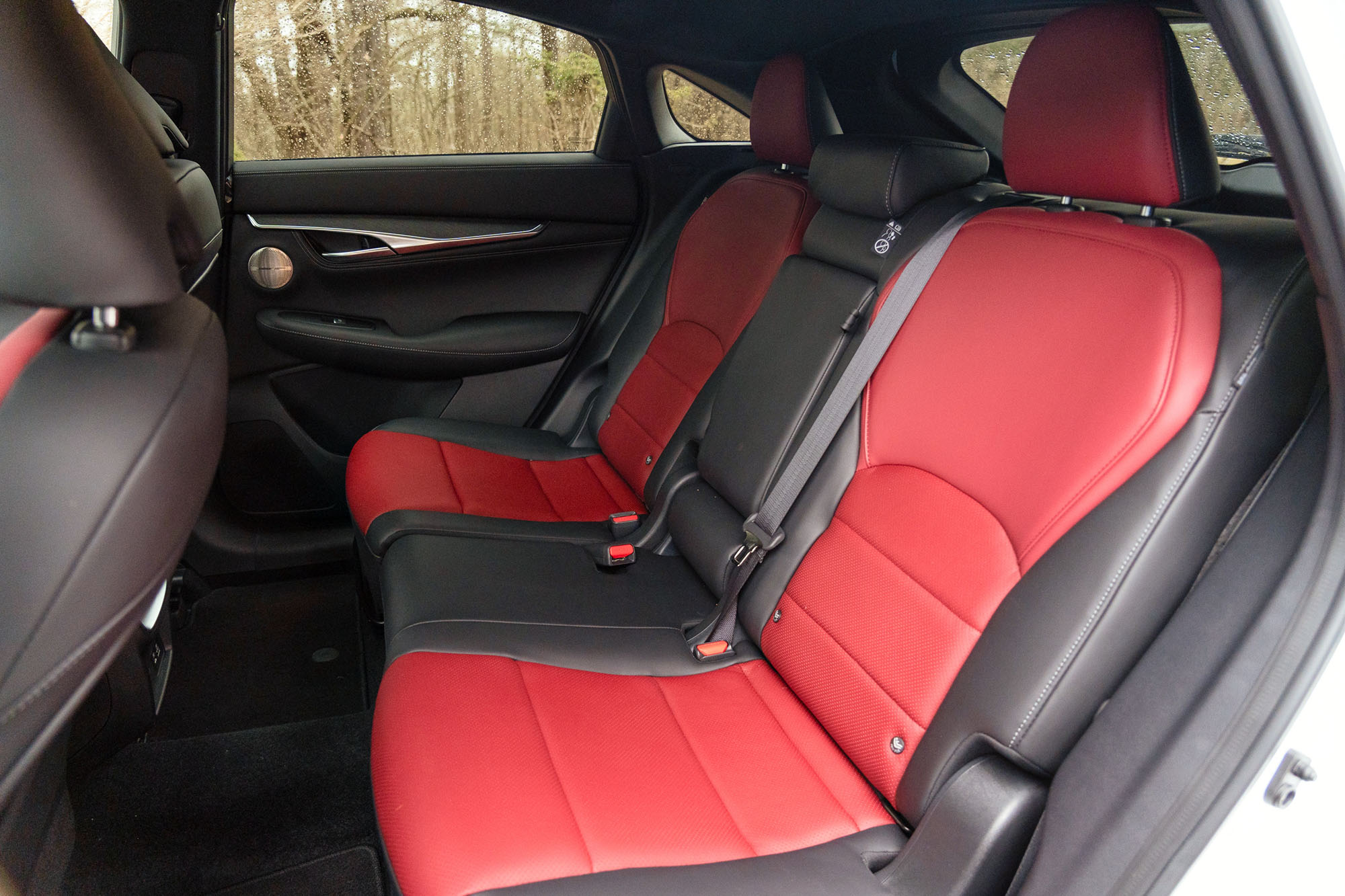 The back seat of a 2024 Infiniti QX55 equipped with red leather