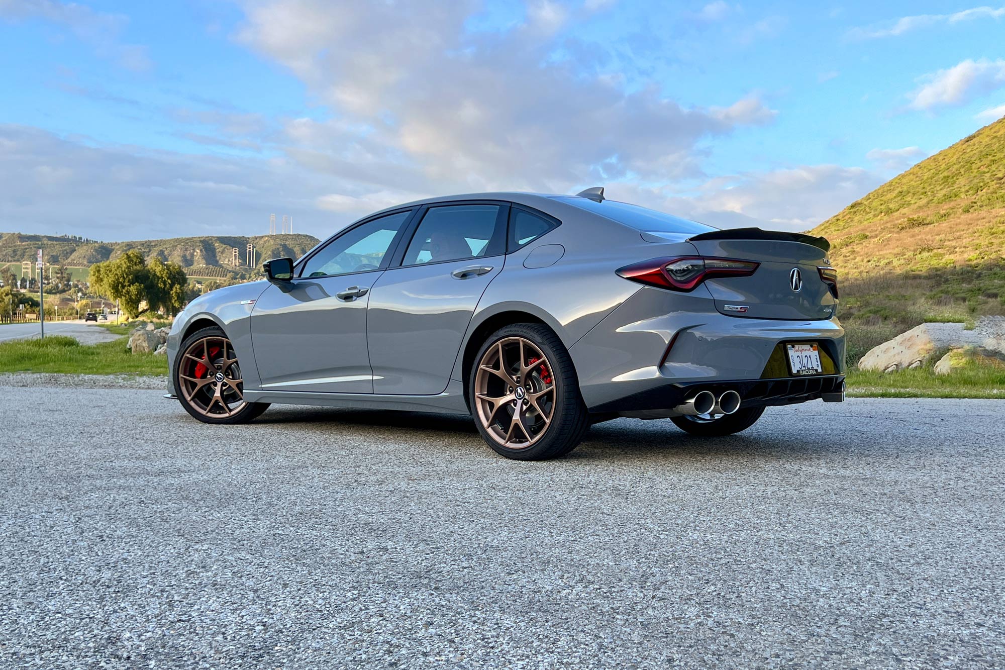 Rear view of a 2024 Acura TLX Type S in Urban Gray with copper-finish 20-inch wheels