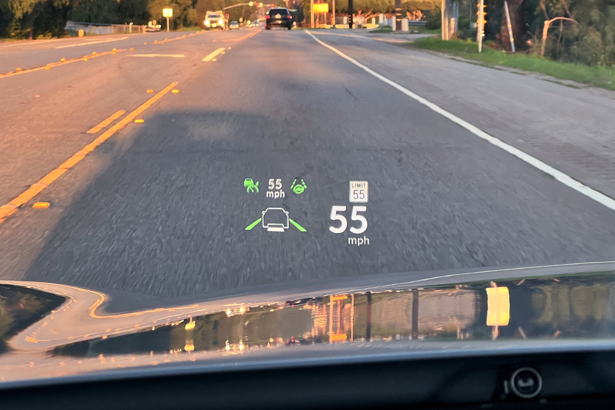 2024 Acura TLX Type S head-up display showing safety feature settings, taken while driving on a road