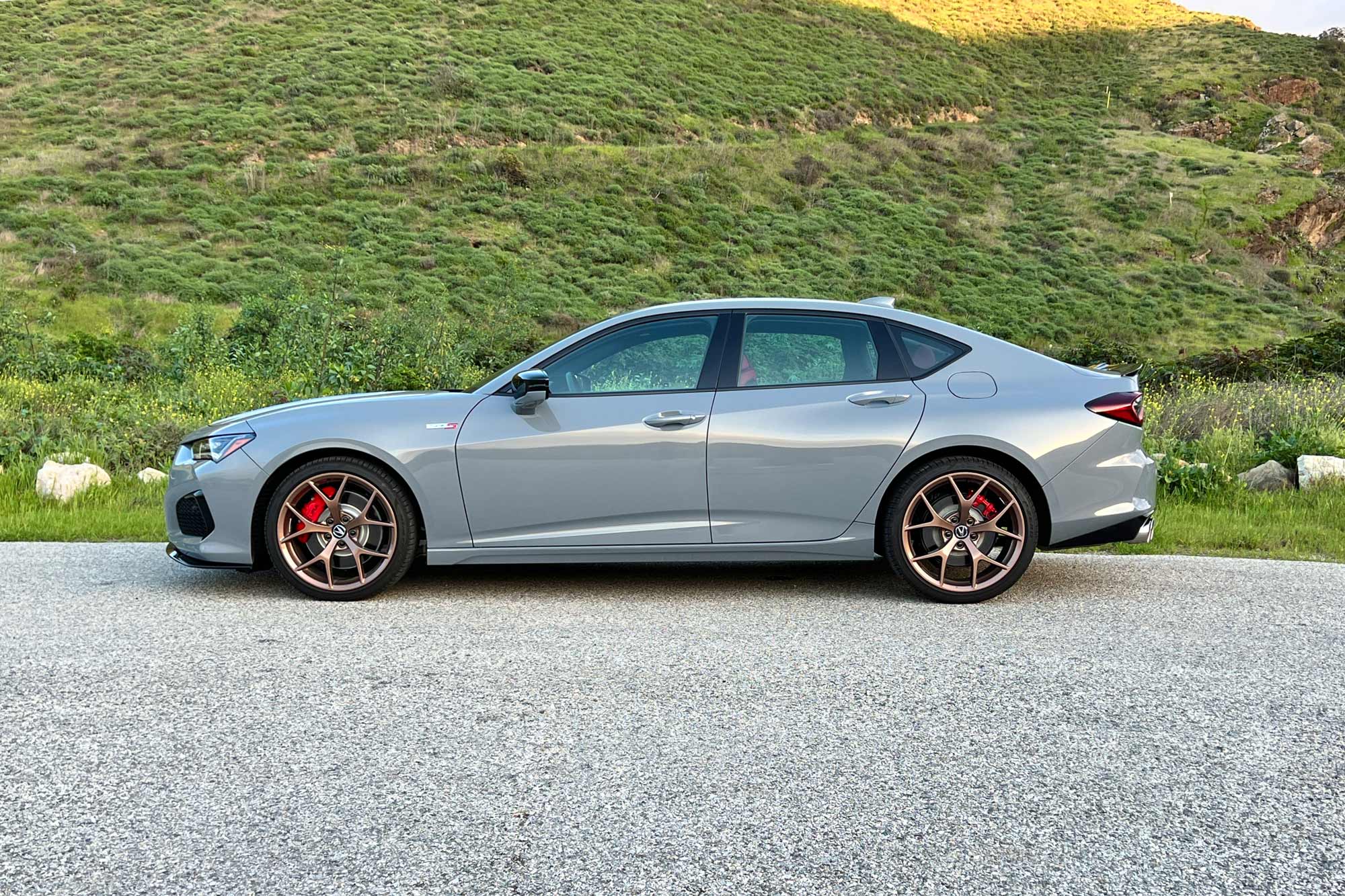 Side view of a 2024 Acura TLX Type S in Urban Gray with copper-finish 20-inch wheels