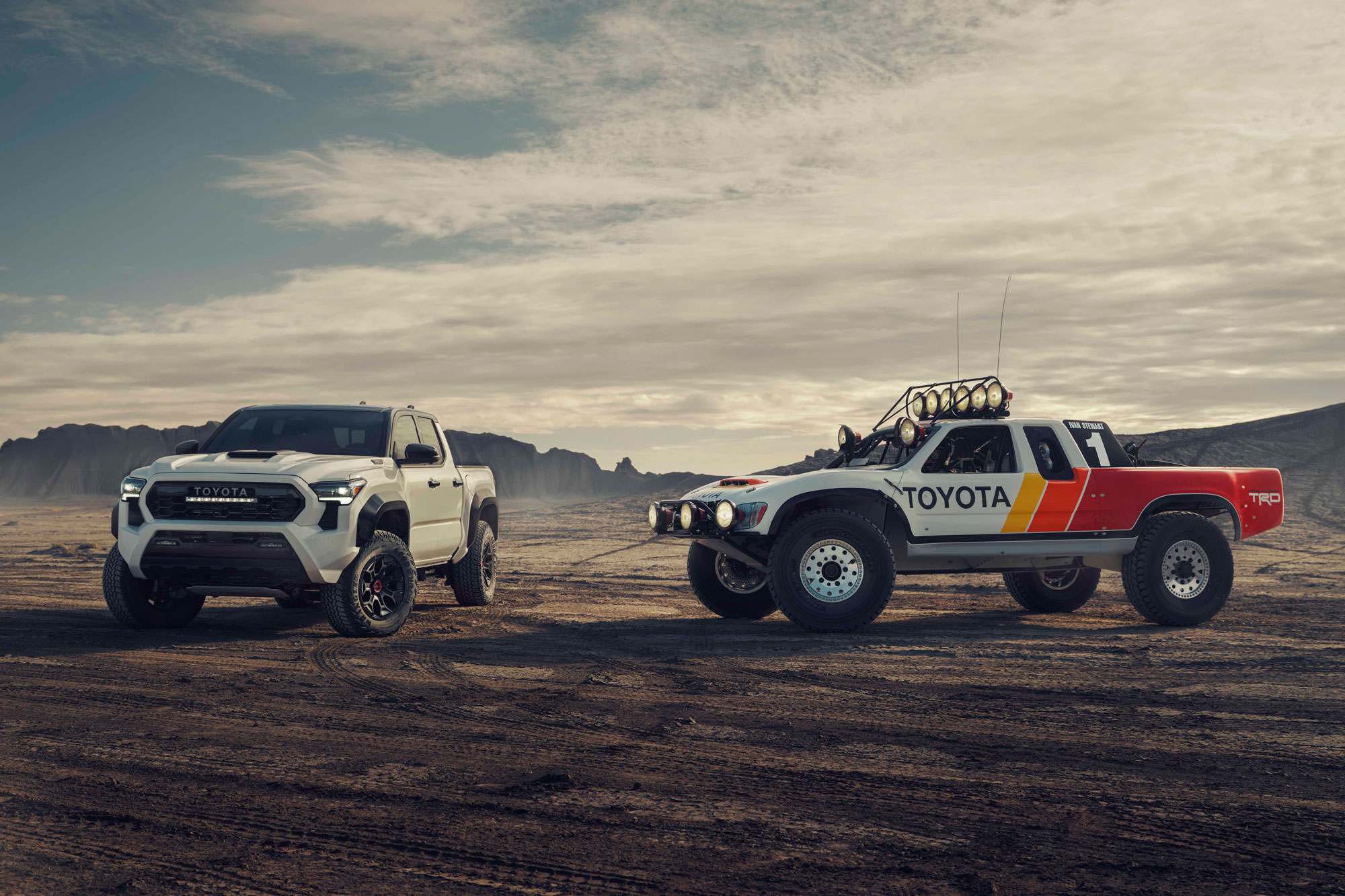 2024 Toyota Tacoma and vintage Toyota off-road race truck.