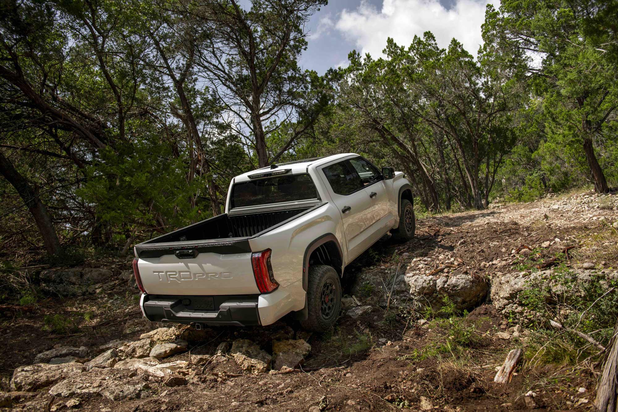 2024 Toyota Tundra TRD Pro driving up a steep rocky hill.