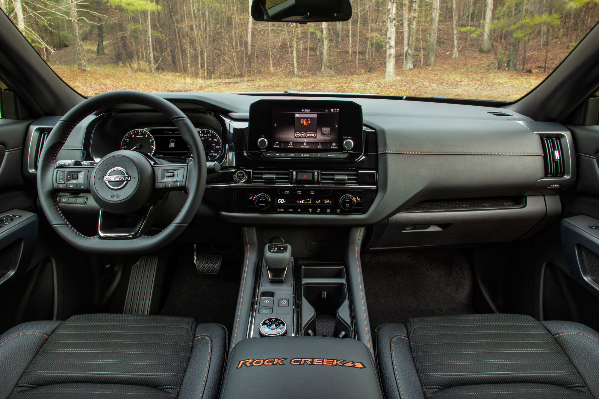 2024 Nissan Pathfinder interior, steering wheel, and infotainment system.