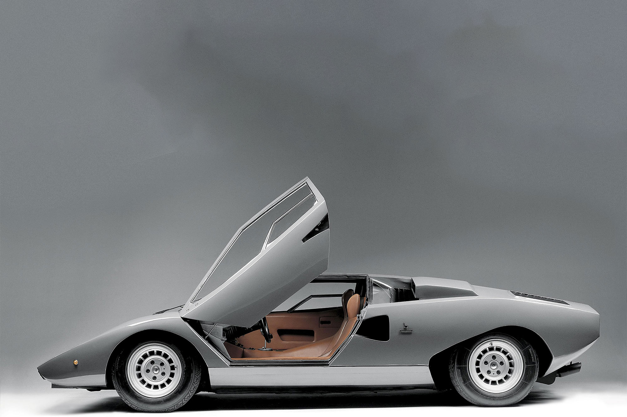 Silver Lamborghini Countach with open scissor doors.