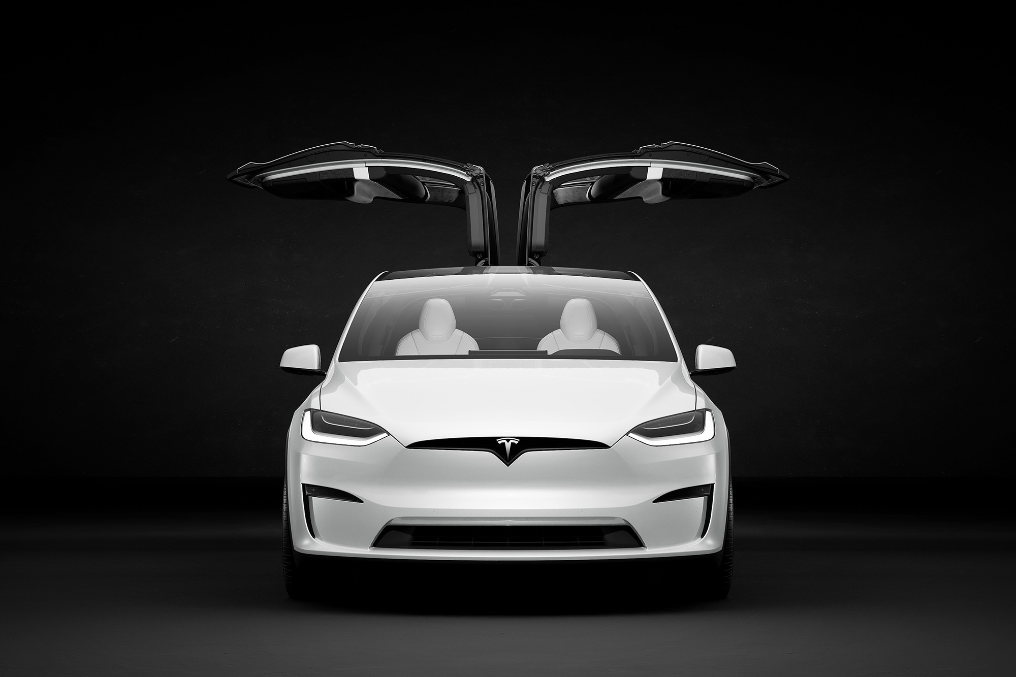 White Tesla Model X with Falcon Wing doors open.