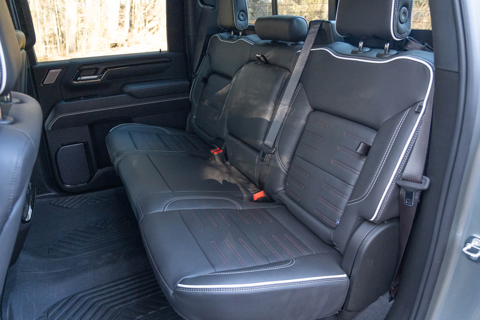 View of the 2024 GMC Sierra 2500HD AT4X AEV interior showing the back seats