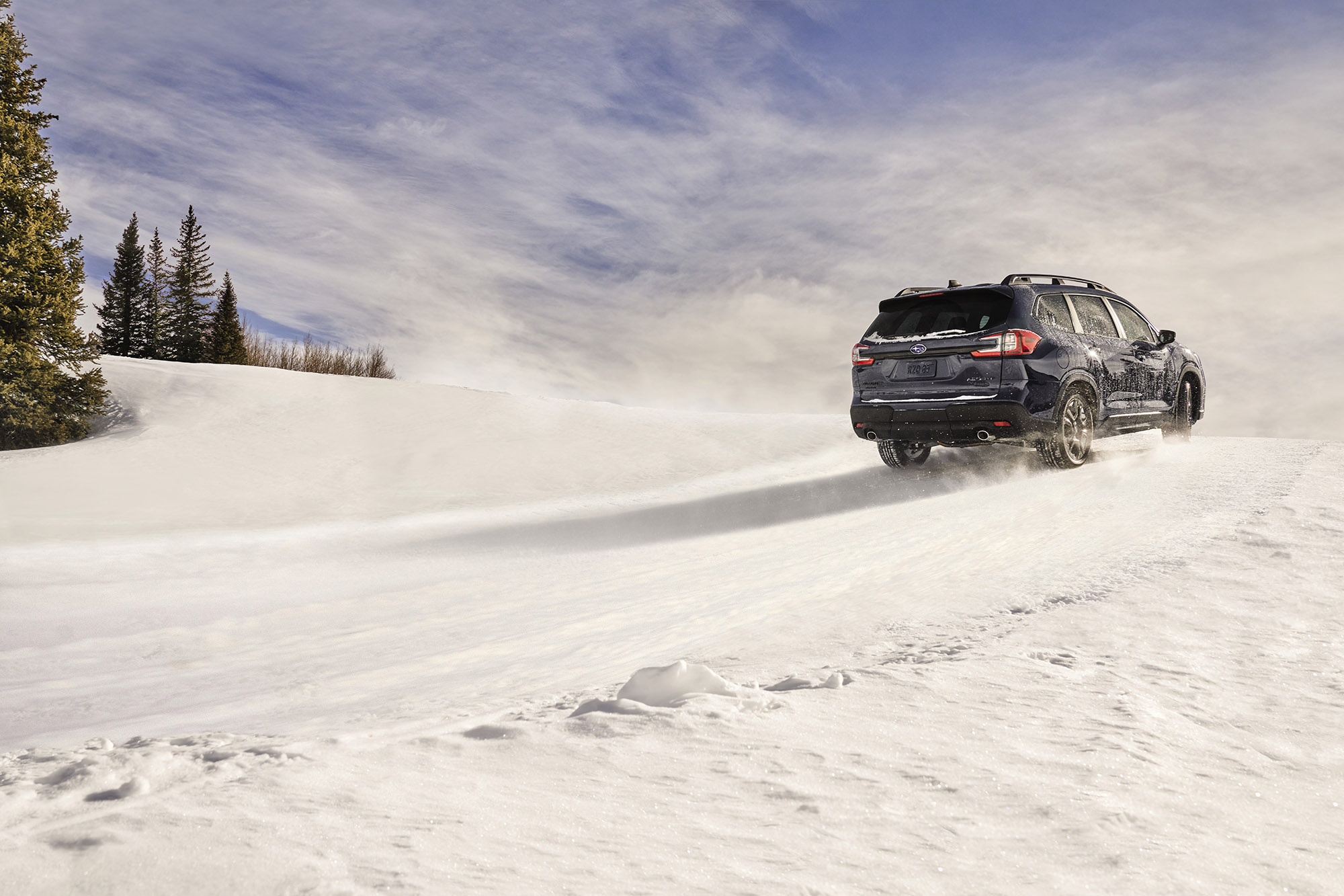 Subaru Ascent driving up snowy road.