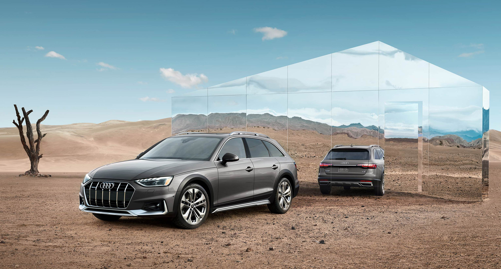 Audi A4 Allroad Prestige in Terra Gray Metallic parked in front of a mirror structure in the desert