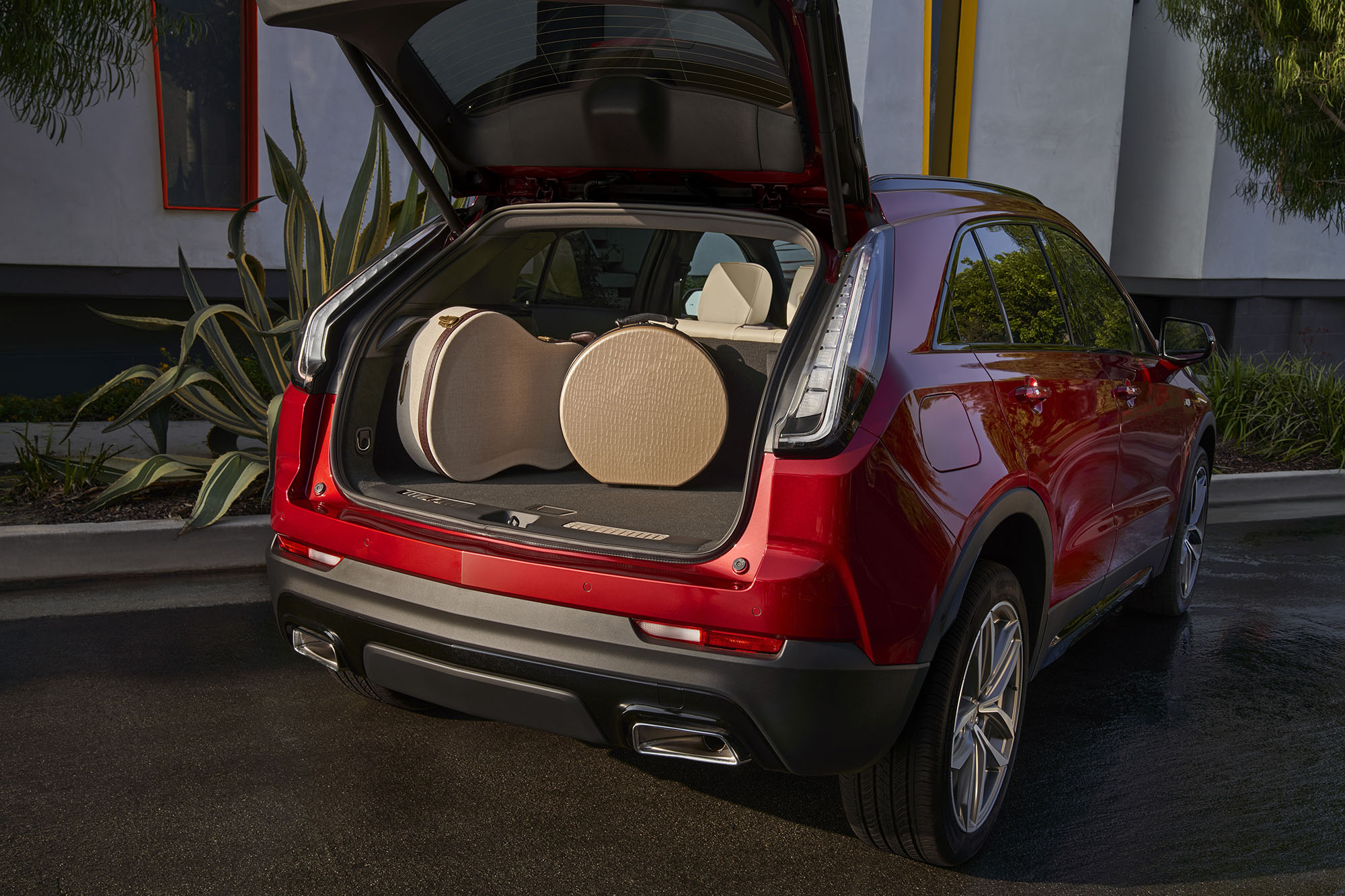 Cadillac XT4 with rear hatch open and musical instruments sitting in the cargo area