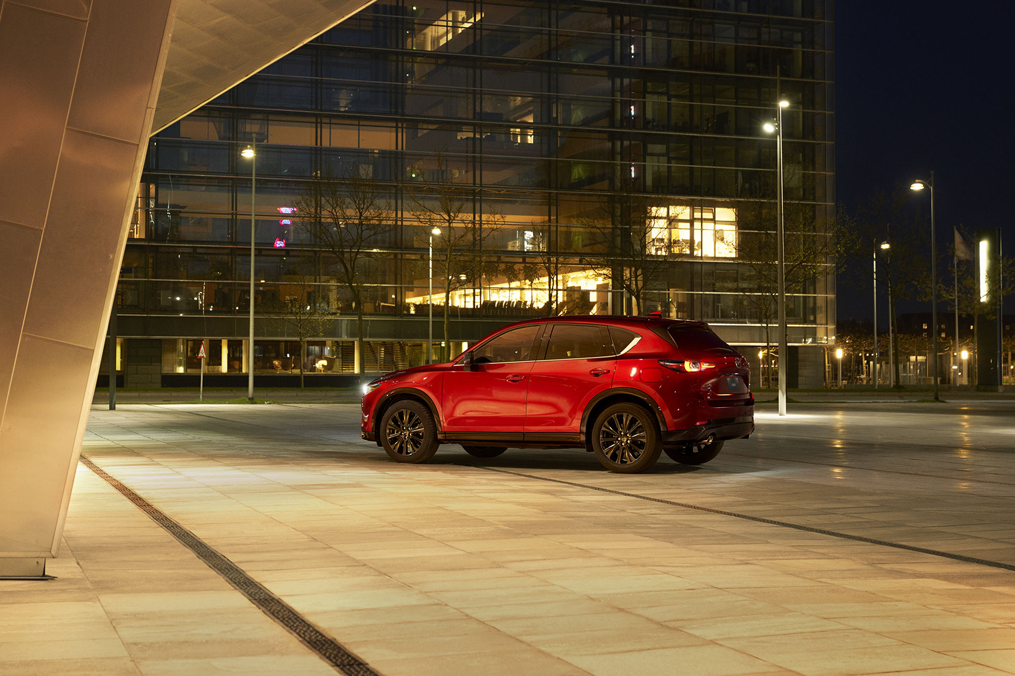 2023 Mazda CX-5 in red, rear-side view