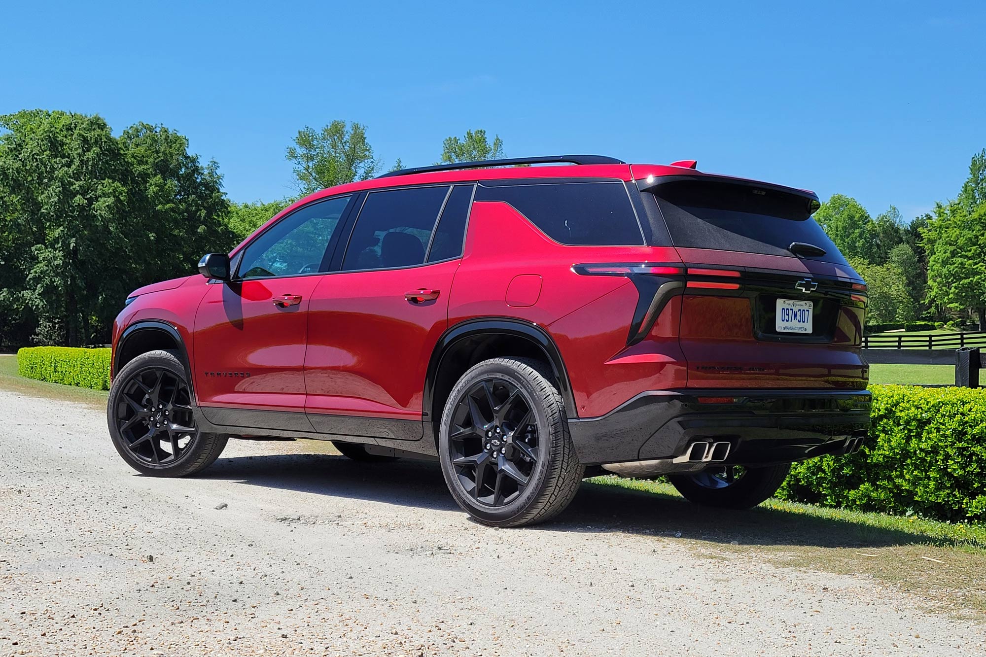Red 2024 Chevrolet Traverse RS parked on a road.
