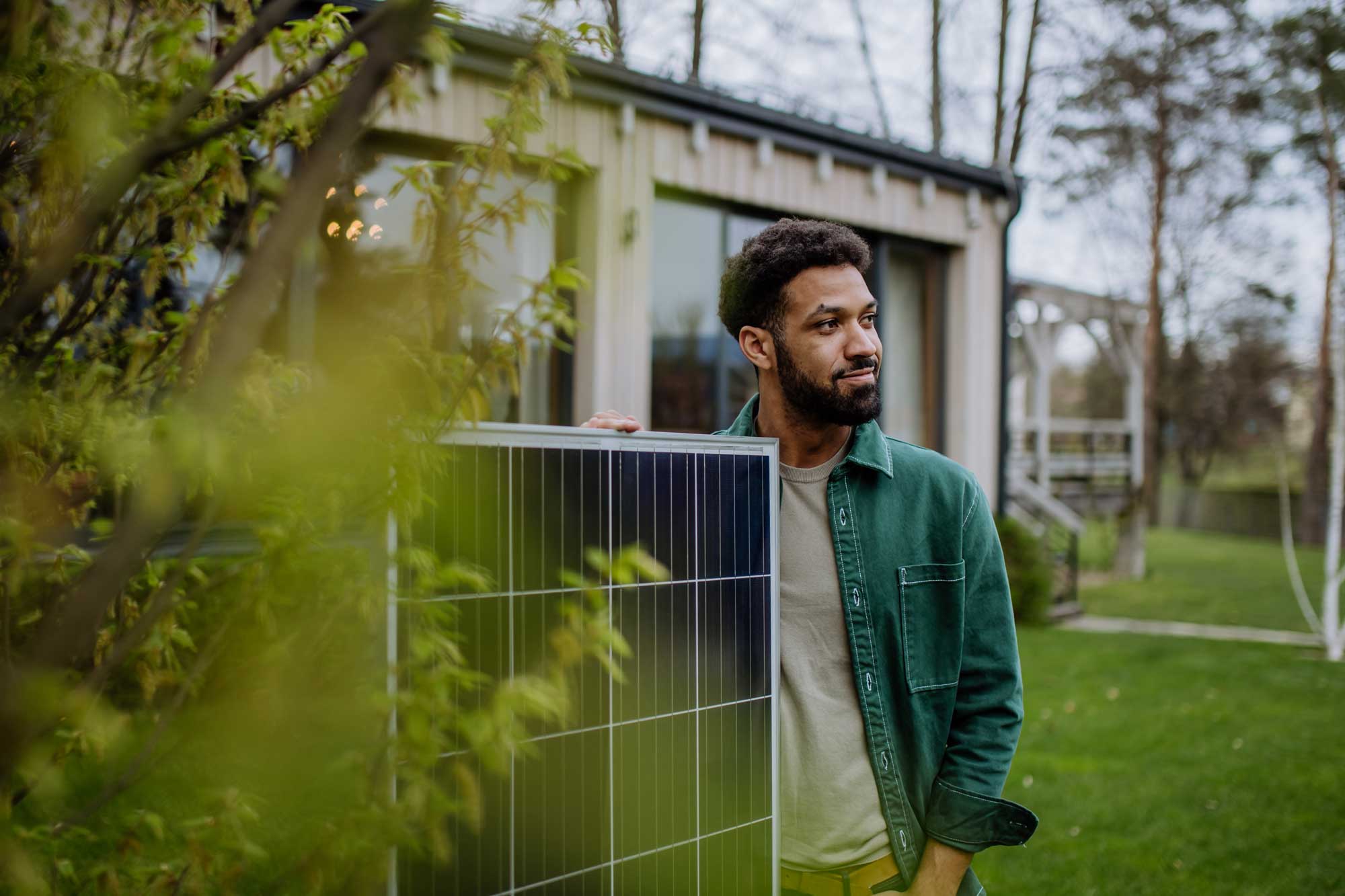Person standing beside solar panel