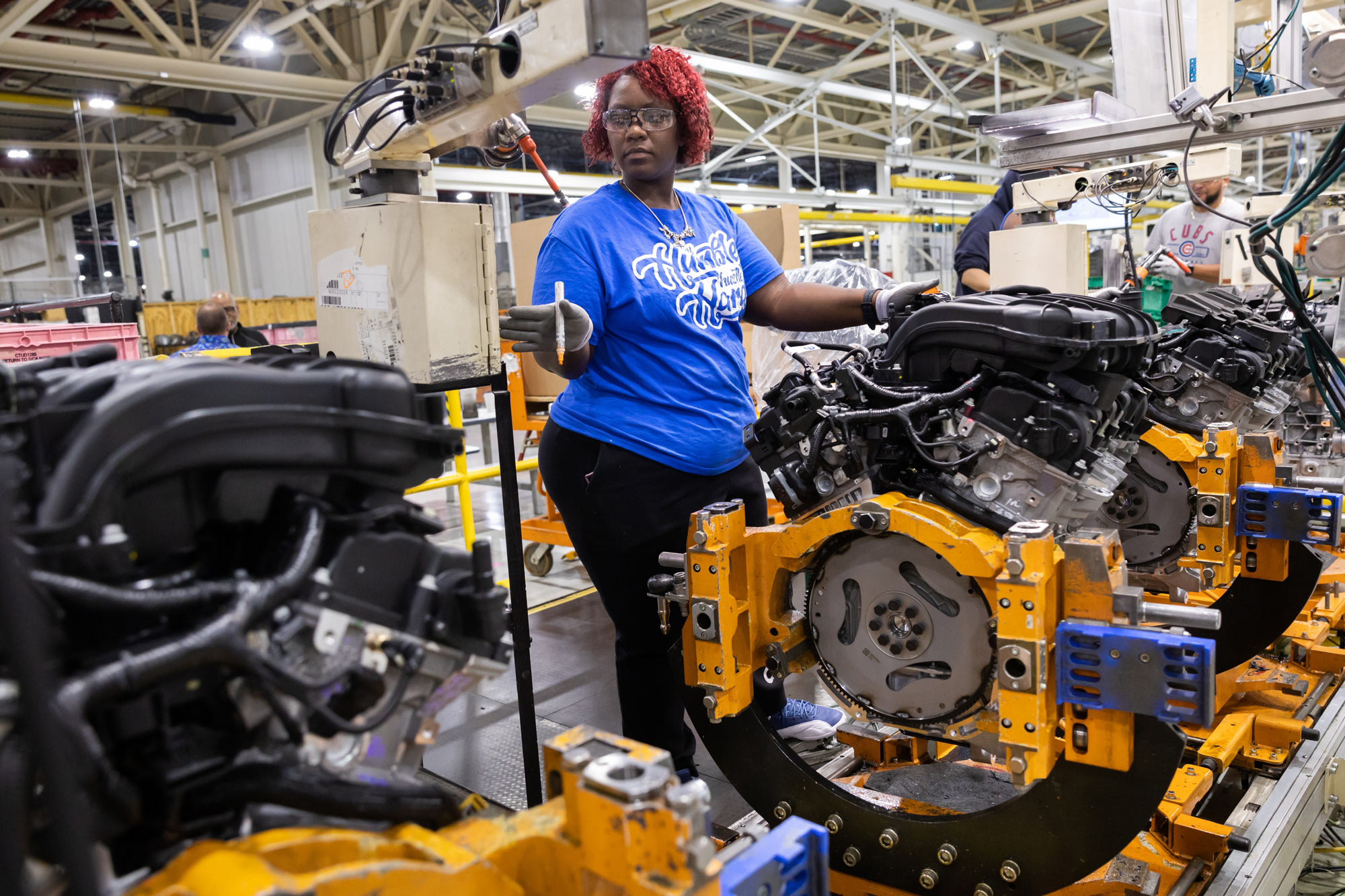 An assembly line worker oversees the final stage of production for the Pentastar 3.6-liter V6 engine