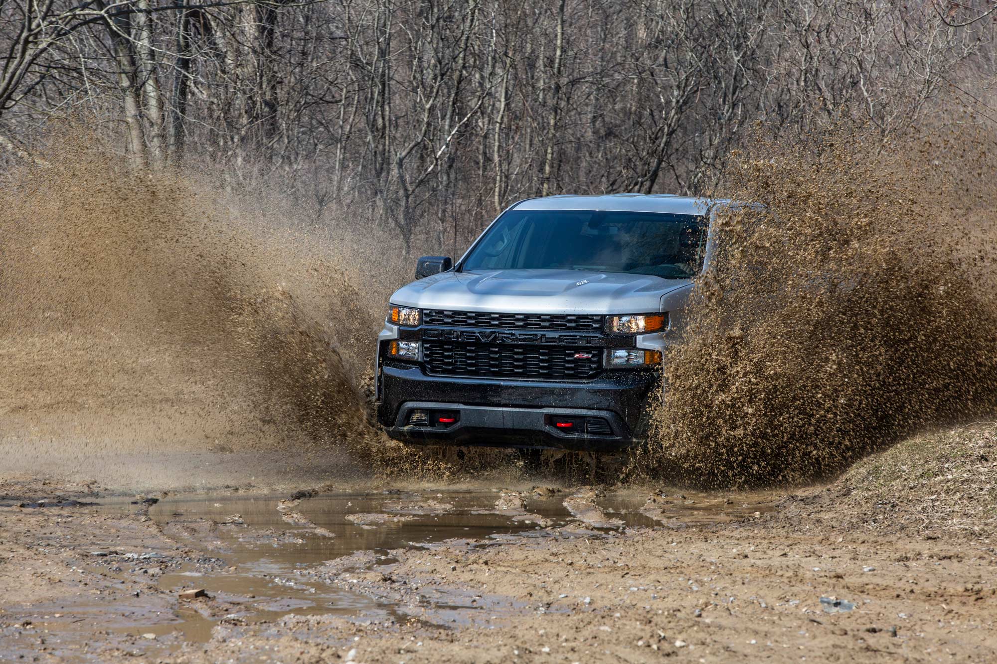 2020 Chevrolet SIlverado Trail Boss driving through deep mud.