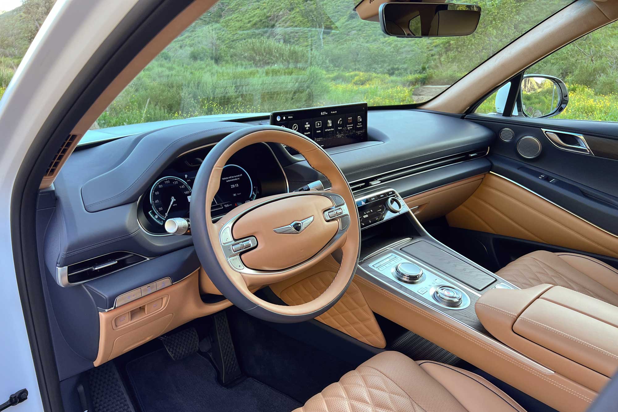 View of the 2024 Genesis GV80 3.5T Prestige Signature interior showing the dashboard and front seats.