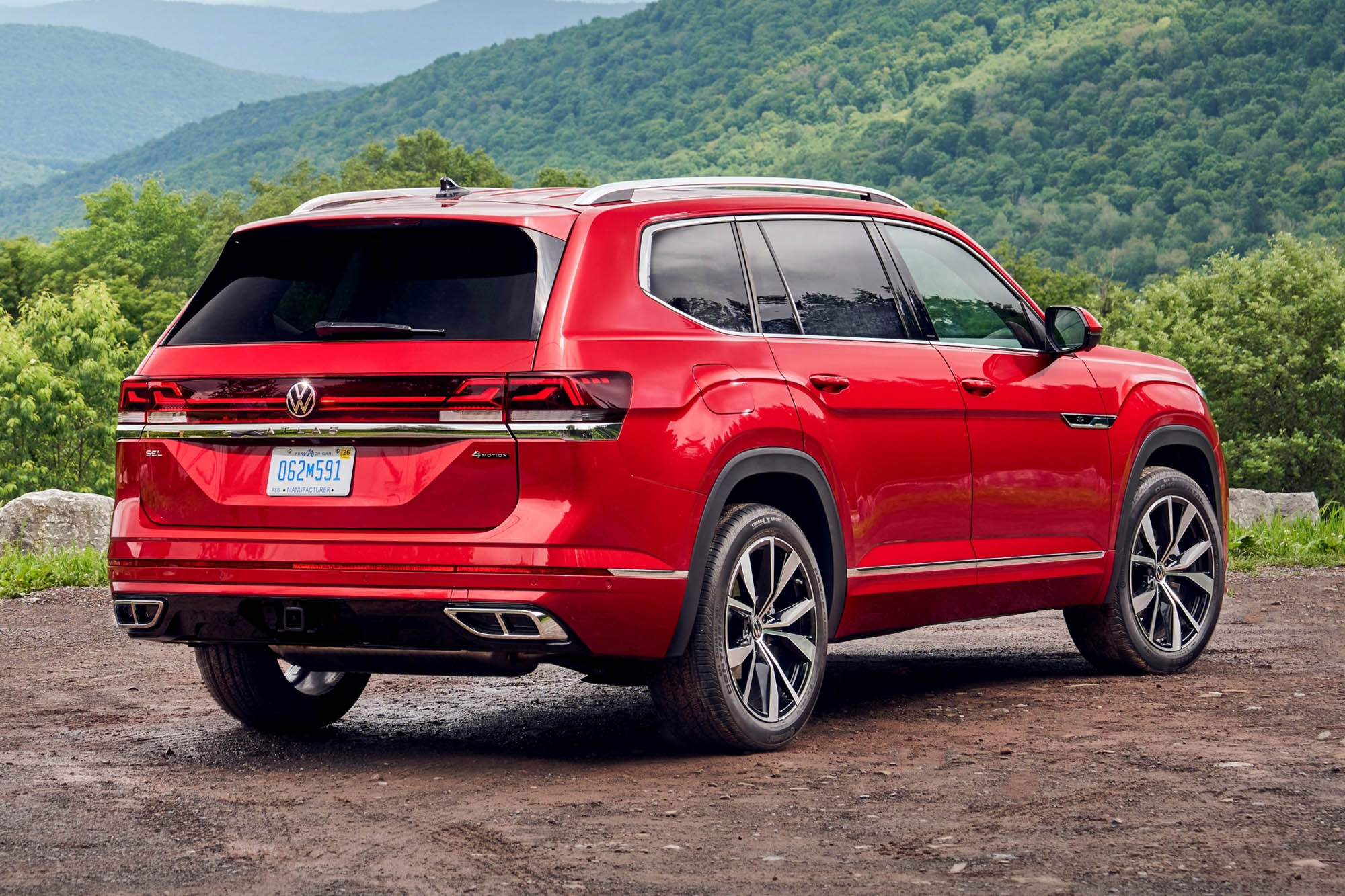 A right rear quarter view of a red 2024 Volkswagen Atlas