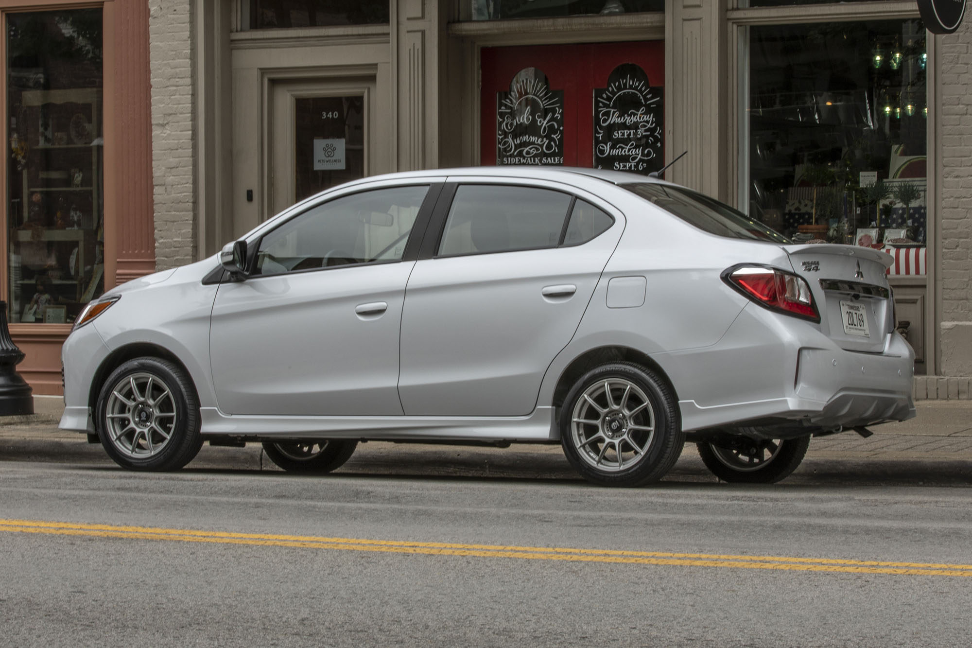 Left rear quarter view of a gray 2024 Mitsubishi Mirage G4 parked on a city street