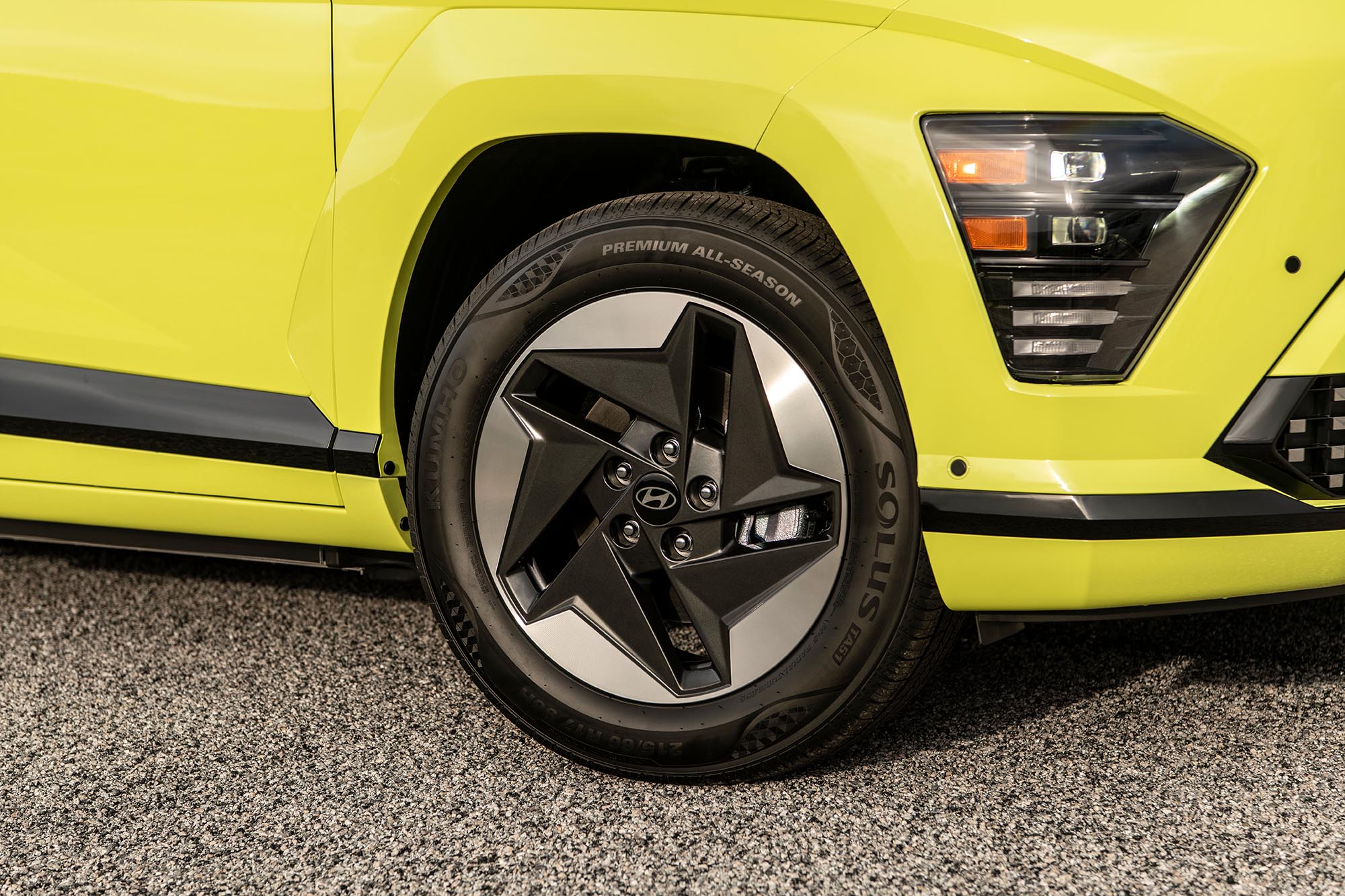 Yellow-green Hyundai Kona EV close-up of wheel and tire.