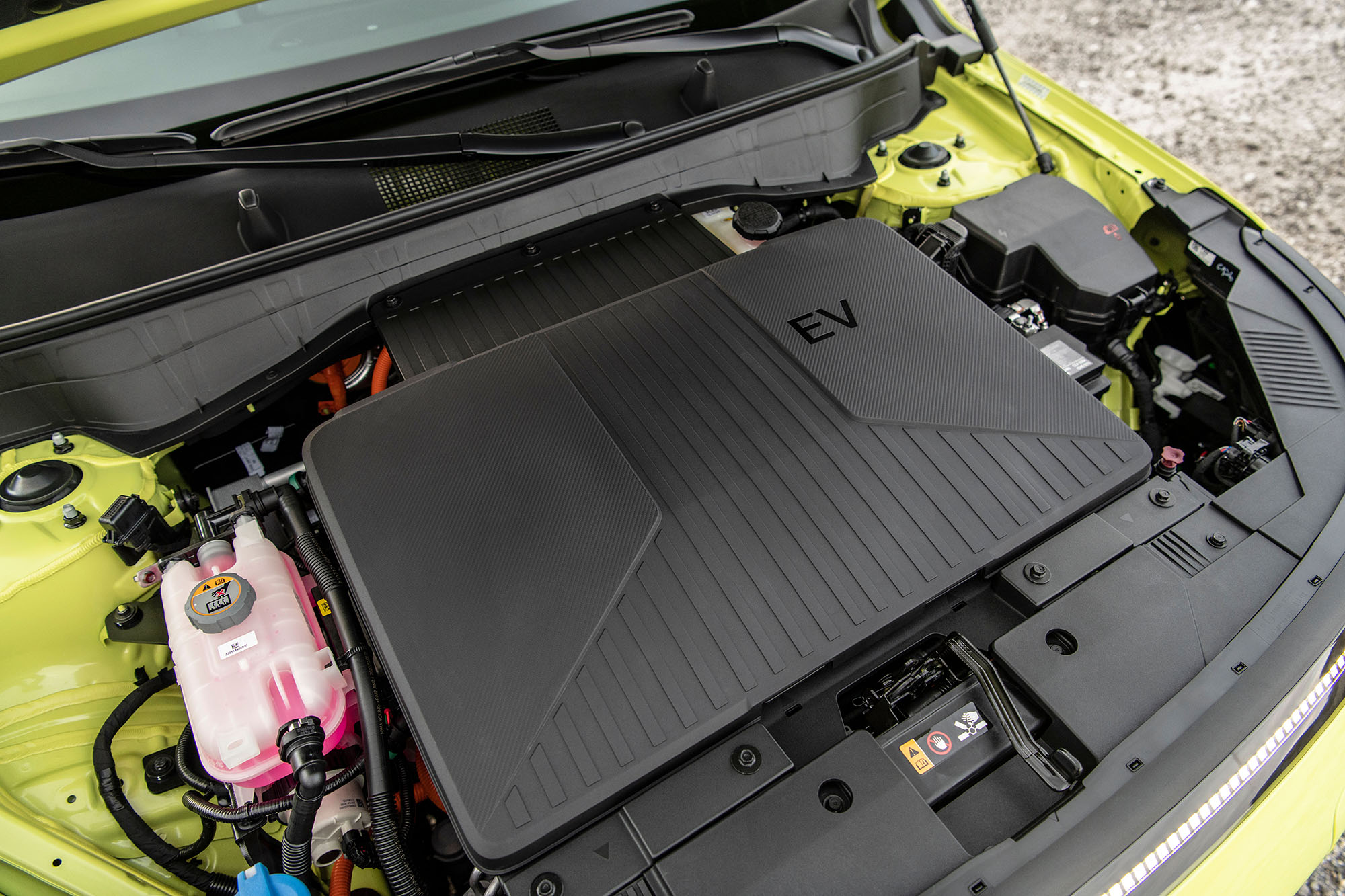 Yellow-green Hyundai Kona EV with open hood.