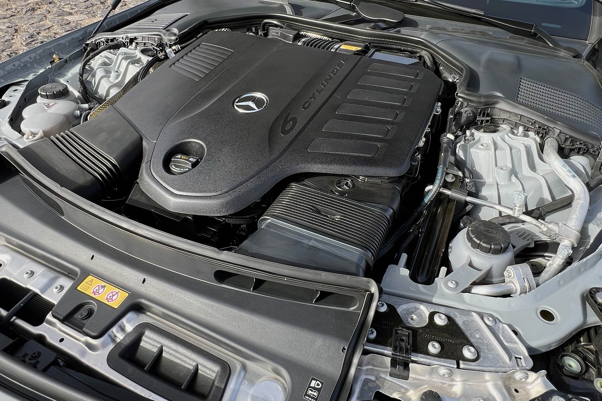 View of a 2024 Mercedes-Benz CLE 450 Cabriolet turbocharged mild-hybrid 3.0-liter inline six-cylinder engine.