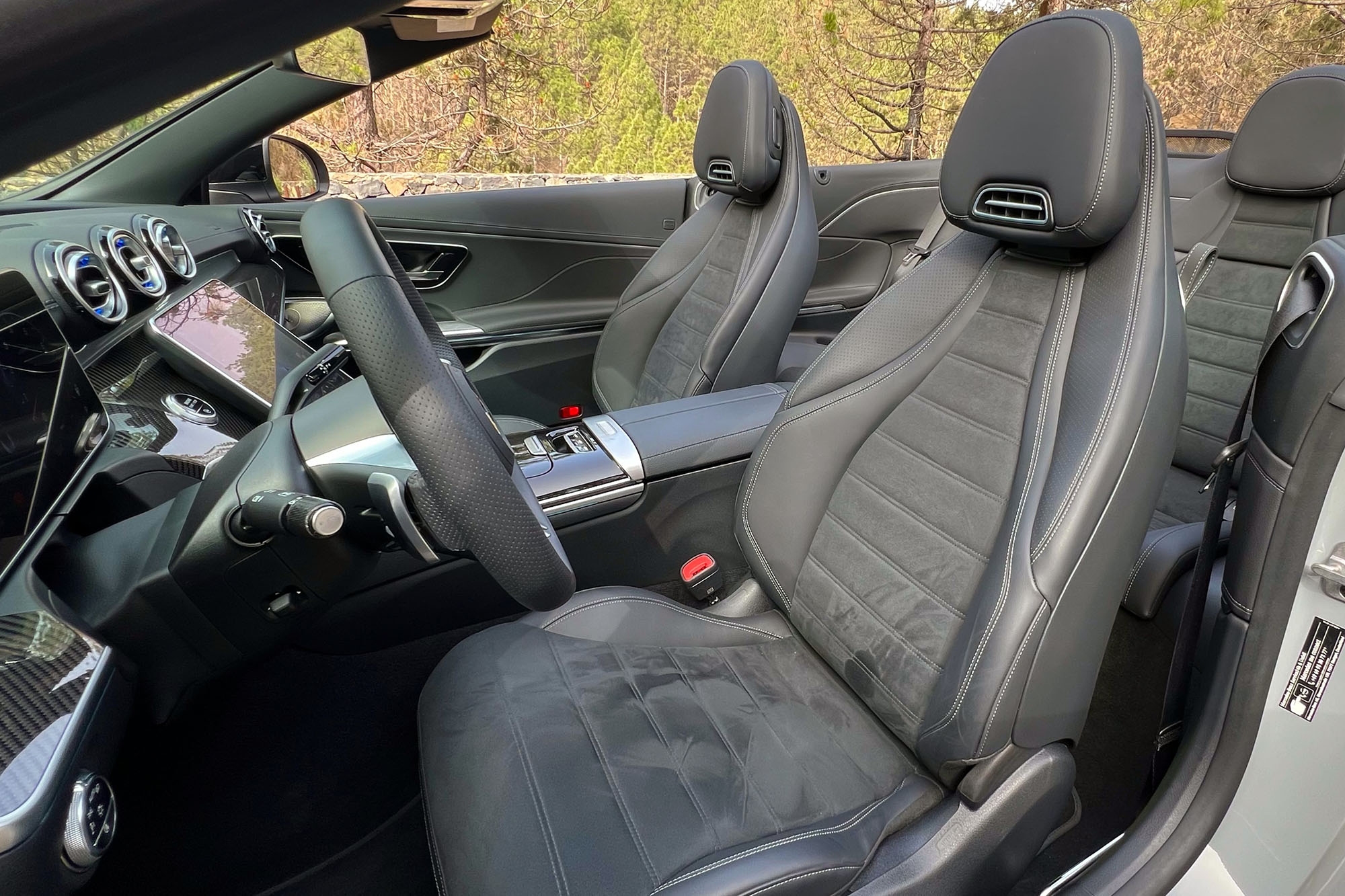 View of a 2024 Mercedes-Benz CLE 450 Cabriolet interior showing the front seats with Airscarf neck heaters.